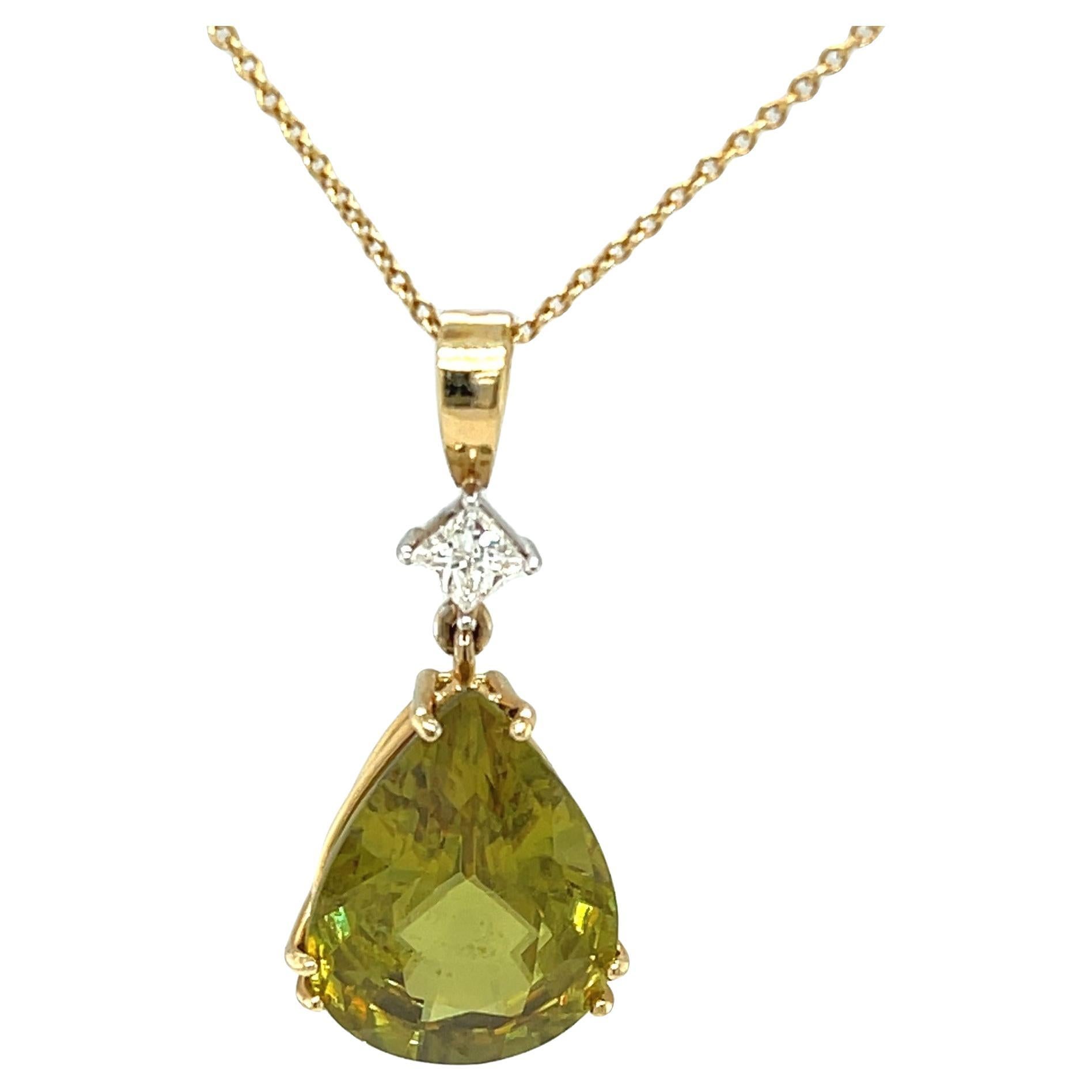 This stunning pendant features a rare 12.58 carat sphene gemstone. This pear-shaped natural gem is a collector's item.  It is exceptionally large, weighing over 10 carats, and is of superfine quality. It possesses a bright olive green color with
