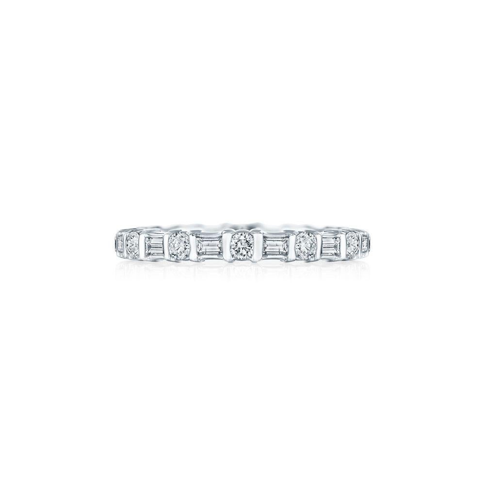 • Crafted in 18KT White Gold, this eternity band is made with 22 alternating round and baguette cut diamonds. The diamonds are secured in a bar setting and has a combining total weight of approximately 1.25 carats.
Worn beautifully on its own or