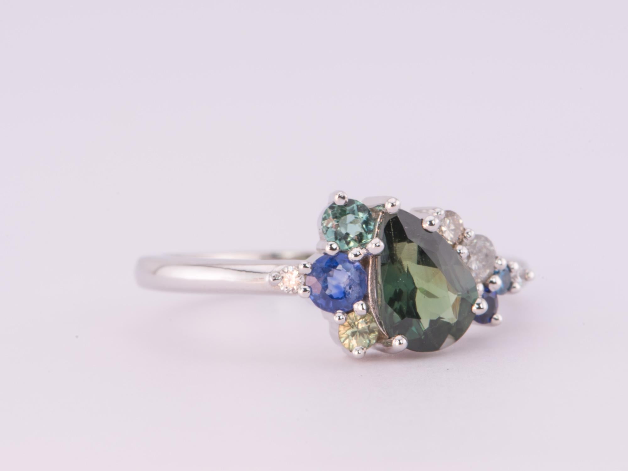 ♥ Solid 14k gold ring set with a beautiful pear-shaped Nigerian sapphire in the center, flanked by a cluster of white, gray, champagne, and blue diamonds, and a few blue green sapphires
♥ Gorgeous blue green color!

♥ US Size 7 (Free resizing up or