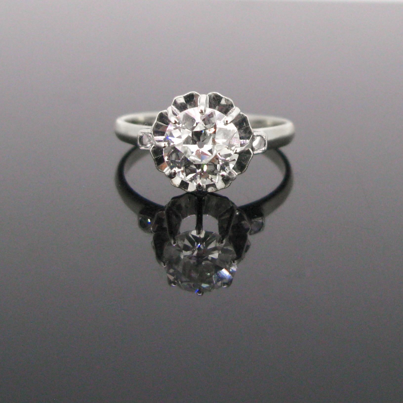 This beautiful ring is directly from the Art Deco era circa 1925. It is made in 18kt white gold and platinum (tested). It is set with an old European cut diamond weighing around 1.25ct with an illusion setting. The diamond is shouldered with two