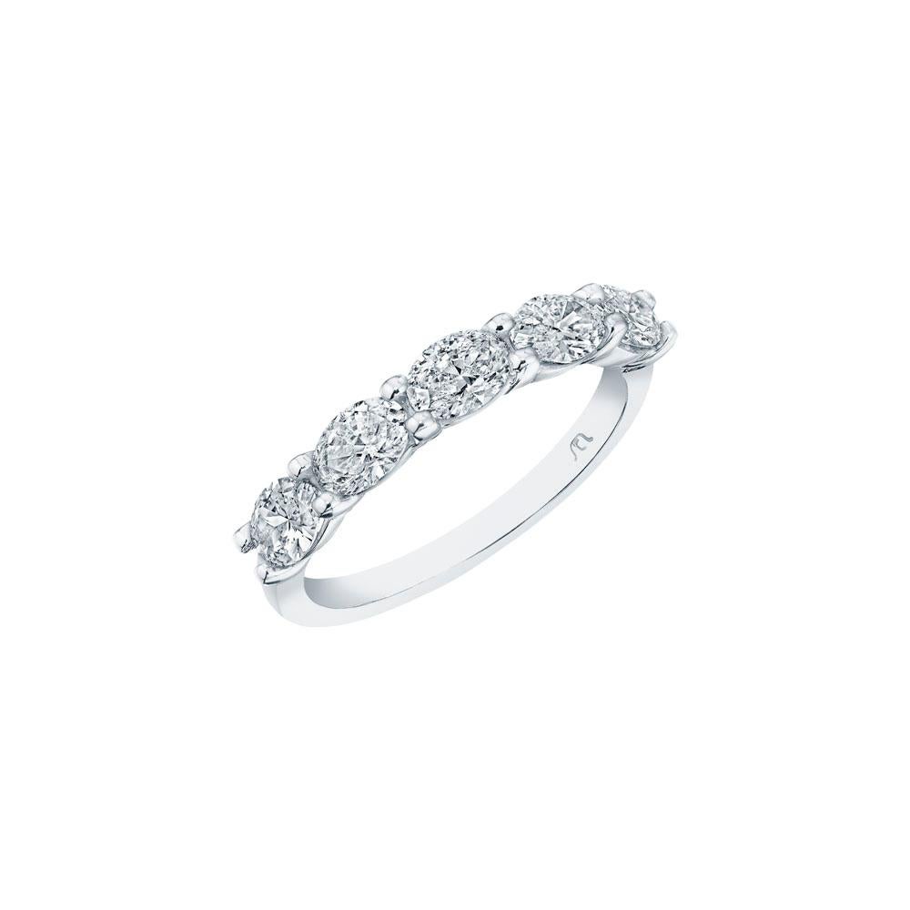 • Crafted in 18KT gold, this band is made with 5 oval cut diamonds, and has a combining total weight of approximately 1.25 carats. The diamonds are set into a shared prong basket setting. Worn beautifully on its own or stacked next to other rings. A