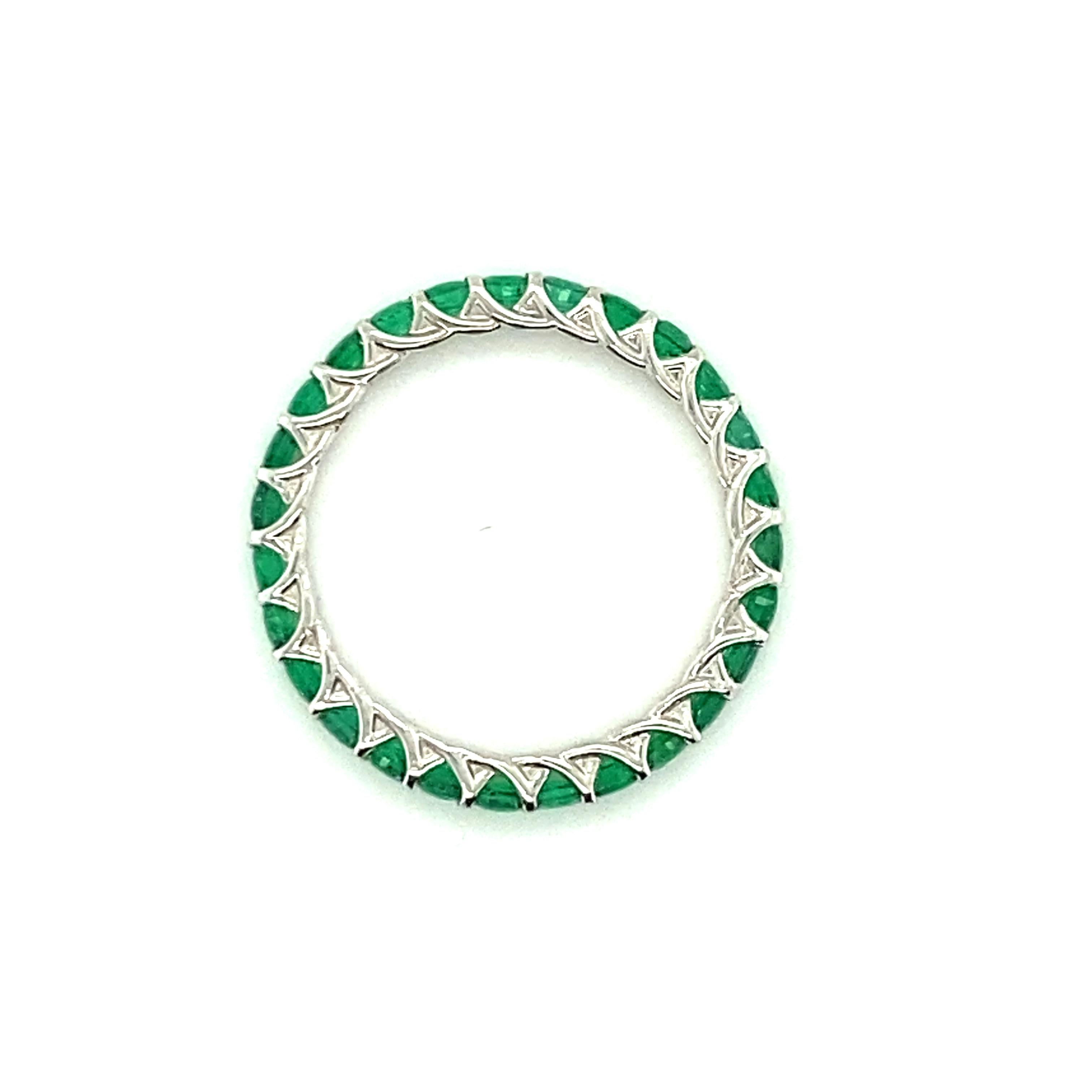 A platinum eternity band set with 27 vibrant green round brilliant-cut emeralds totaling approximately 1.25cts.  Emeralds are crisp and exceptionally clean - it is difficult to find inclusions even under 10x magnification, which makes the emeralds