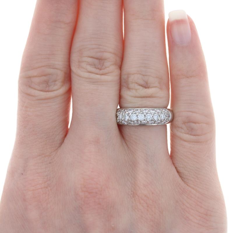 Dazzling radiance awaits with this gorgeous ring! Fashioned in a wide band style, this piece showcases three sparkling rows of icy white diamonds set in heirloom-quality platinum. 

This ring is a size 5 - 5 1/4, but it can be re-sized up 1 size for