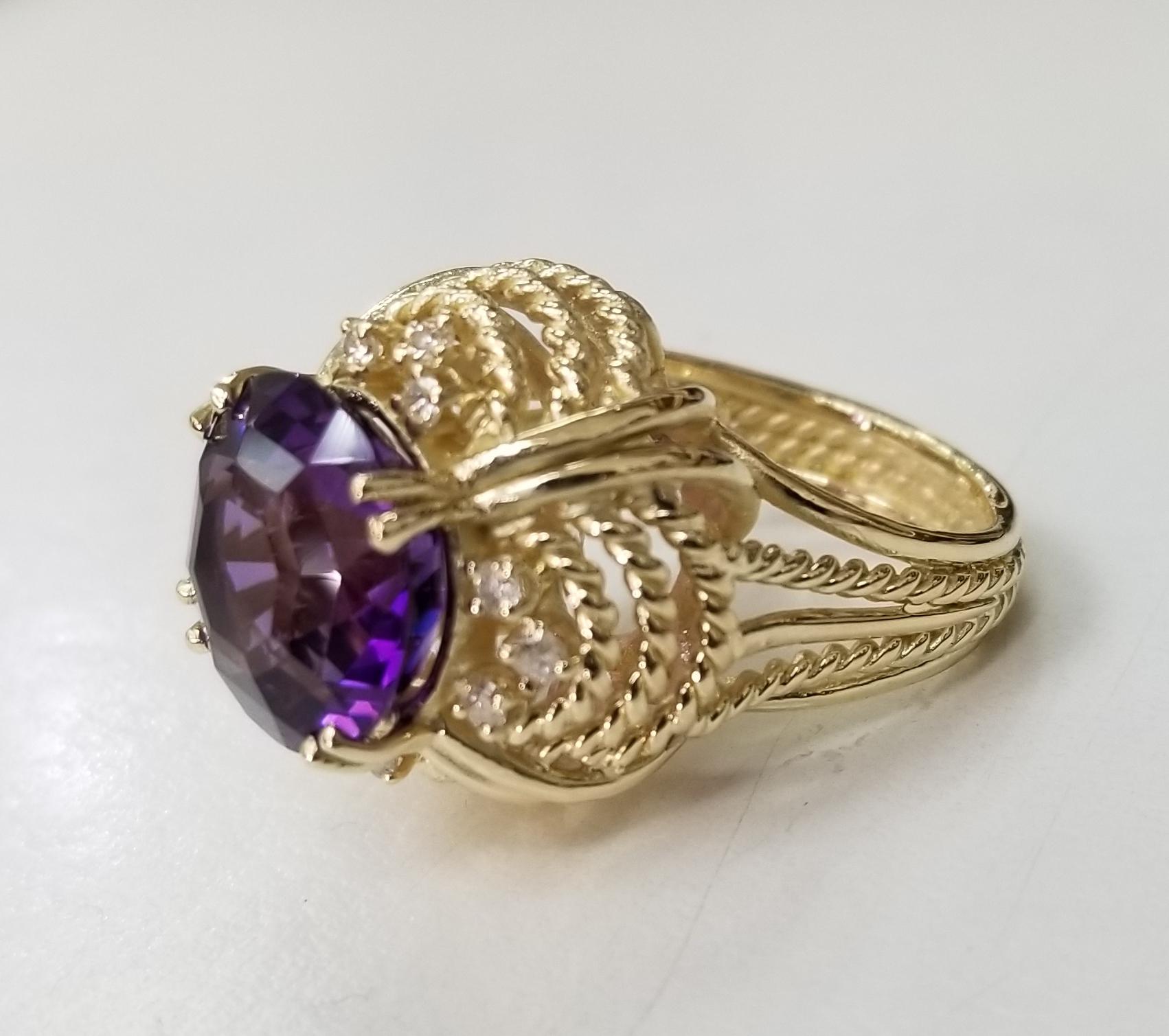 14k yellow gold amethyst and diamond cocktail ring, containing 1 12.5mm round amethyst of gem quality weighing 7.02cts. and 12 round full cut diamonds weighing .36pts. in a delicate and airy rope ring.  This ring is a size 5.75 but we will size to