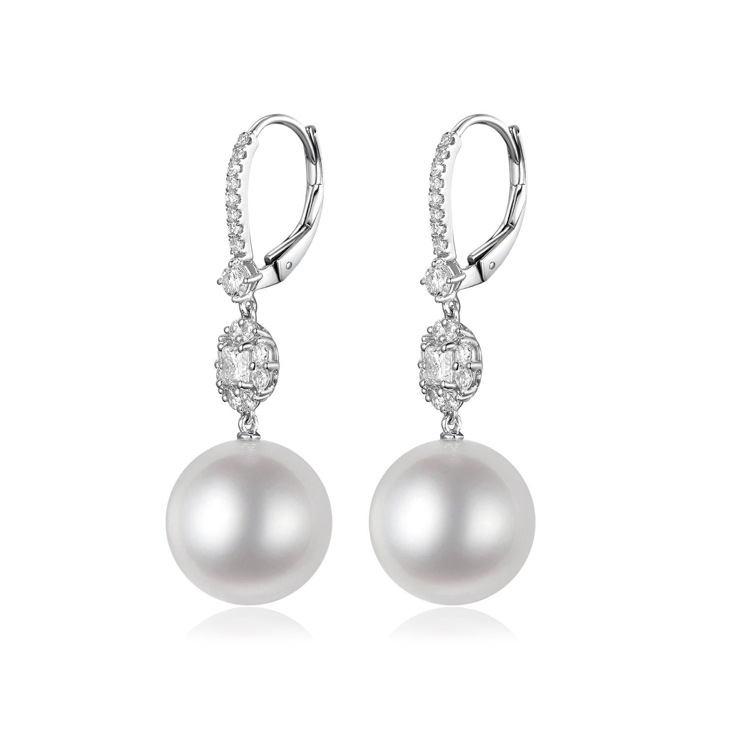 These earrings are a luxurious display of elegance, crafted from 14-karat white gold. Each earring is adorned with a significant 12mm South Sea pearl, renowned for its magnificent size and lustrous shine. The pearls dangle with a poised elegance,