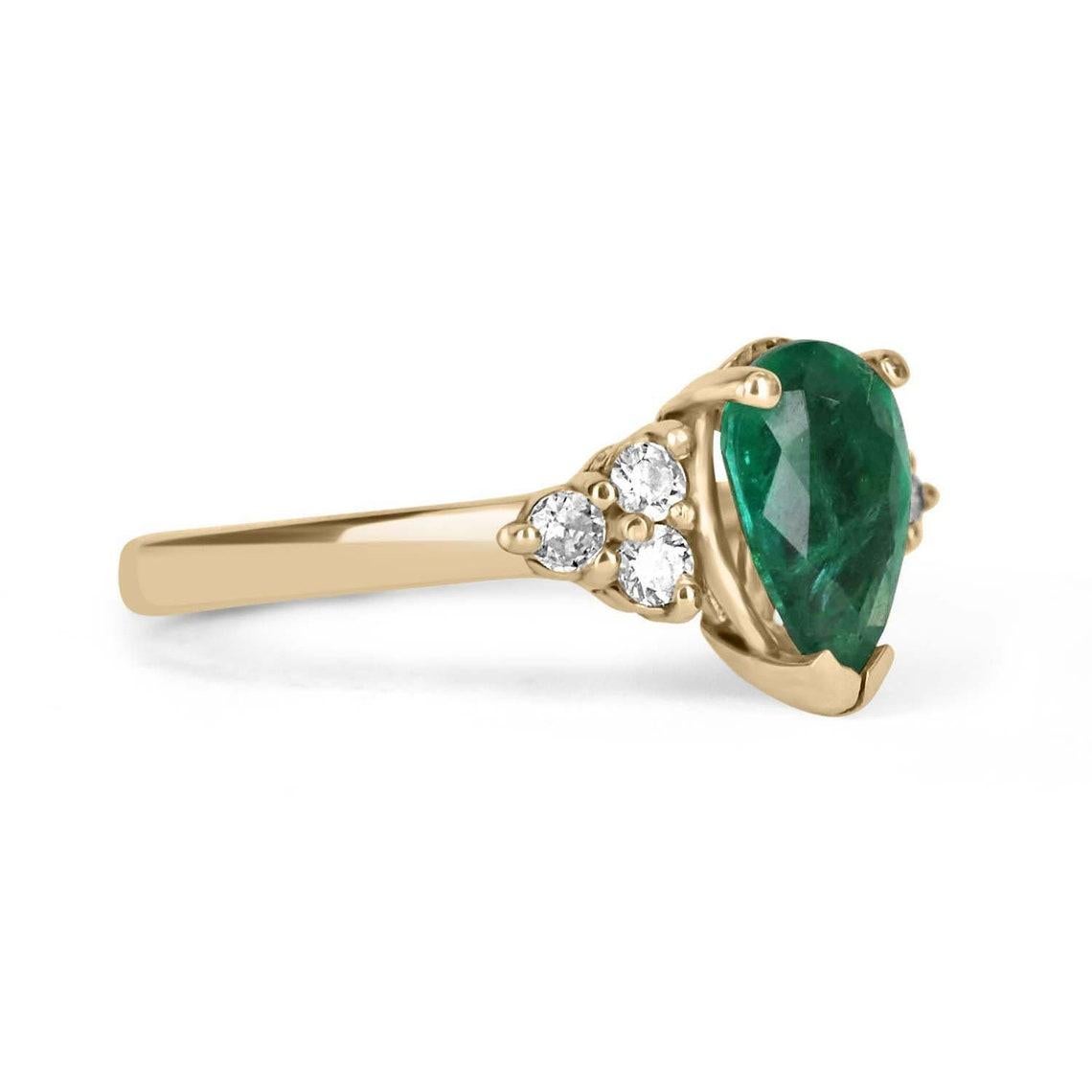 A pear emerald and diamond 14K ring. Dexterously handcrafted in gleaming solid 14K yellow gold, this ring features a 1.0-carat natural emerald, teardrop set in a secure three-prong setting. This extraordinary emerald has stunning green color, strong