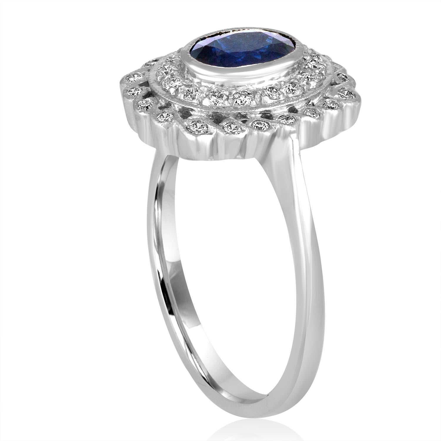 Art Deco Revival Style Ring.
The ring is 18K White Gold
There are 0.50 Carats in Diamonds H SI
The center stone is an oval blue sapphire 0.76 Carats
The ring is a size 6.75, sizable.
The ring measures 0.50