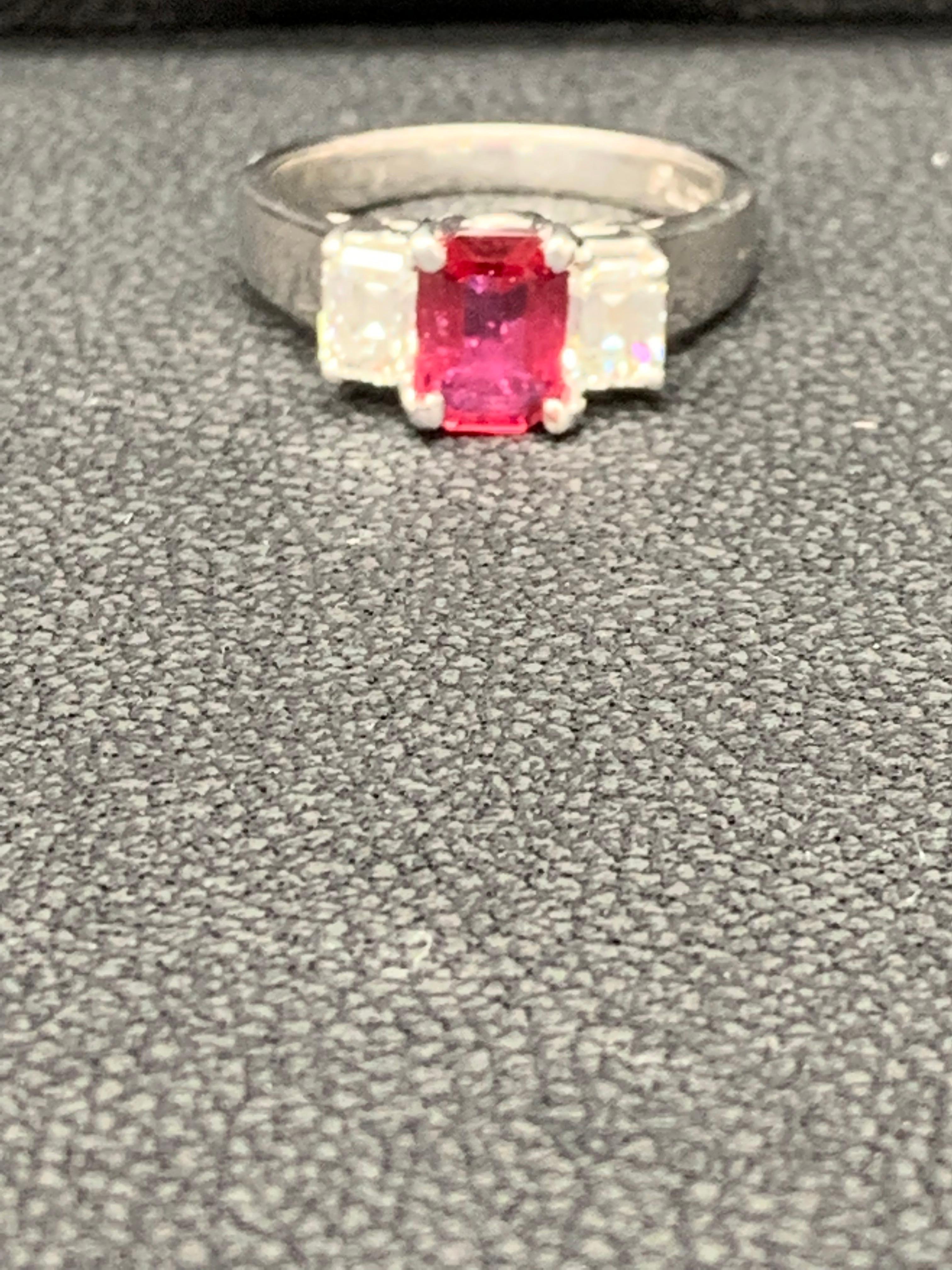 Showcases an Emerald cut, Ruby weighing 1.26 carats, flanked by two brilliant baguette diamonds weighing 1.34 carats total. Elegantly set in a polished platinum composition.
