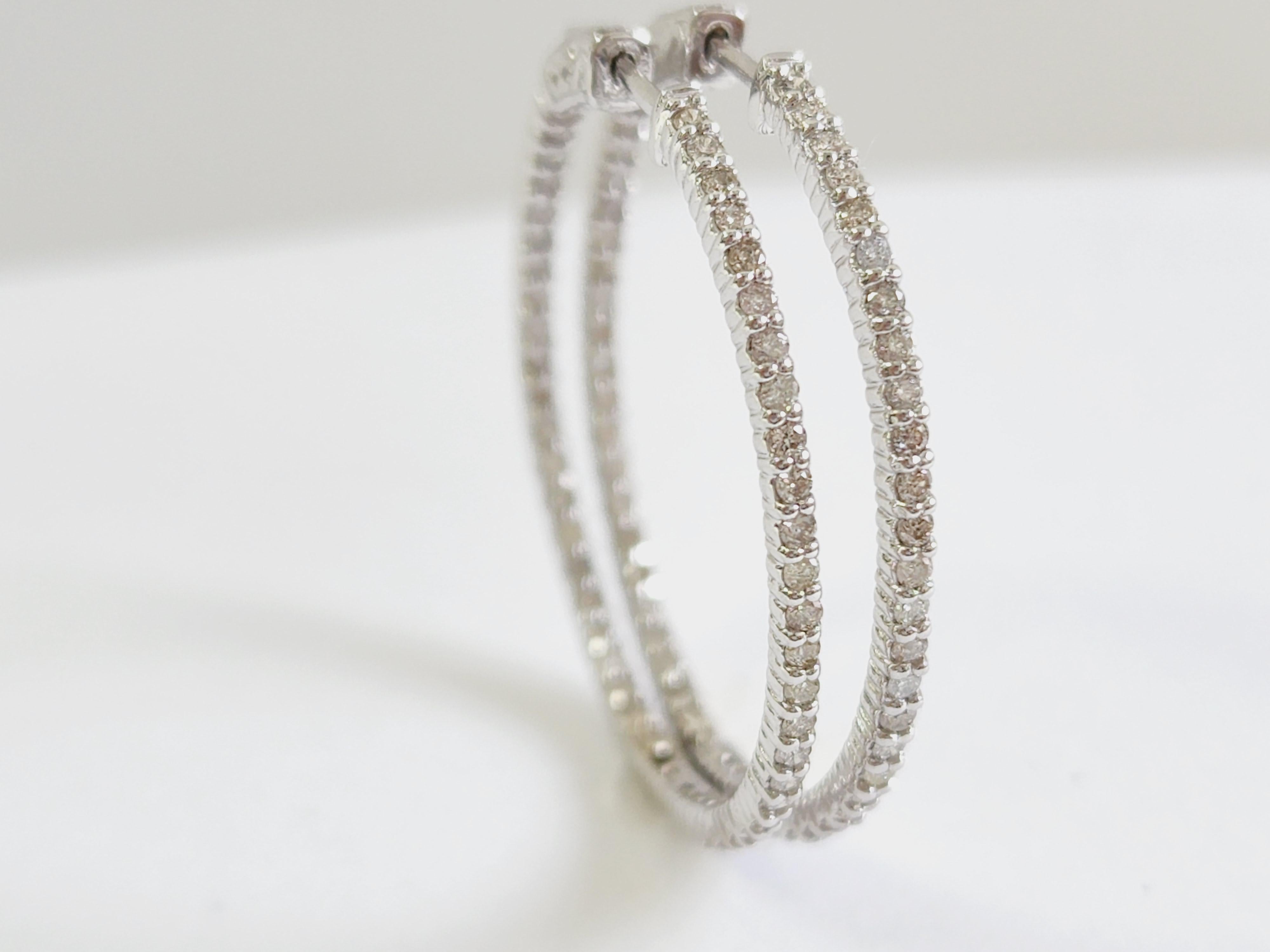 Beautiful pair of diamond inside out hoop earrings in 14k white gold. Secures with snap closure for wear. 
Measures 1.25 inch x 1.25 inch diameter. 
Average I Color, SI Clarity