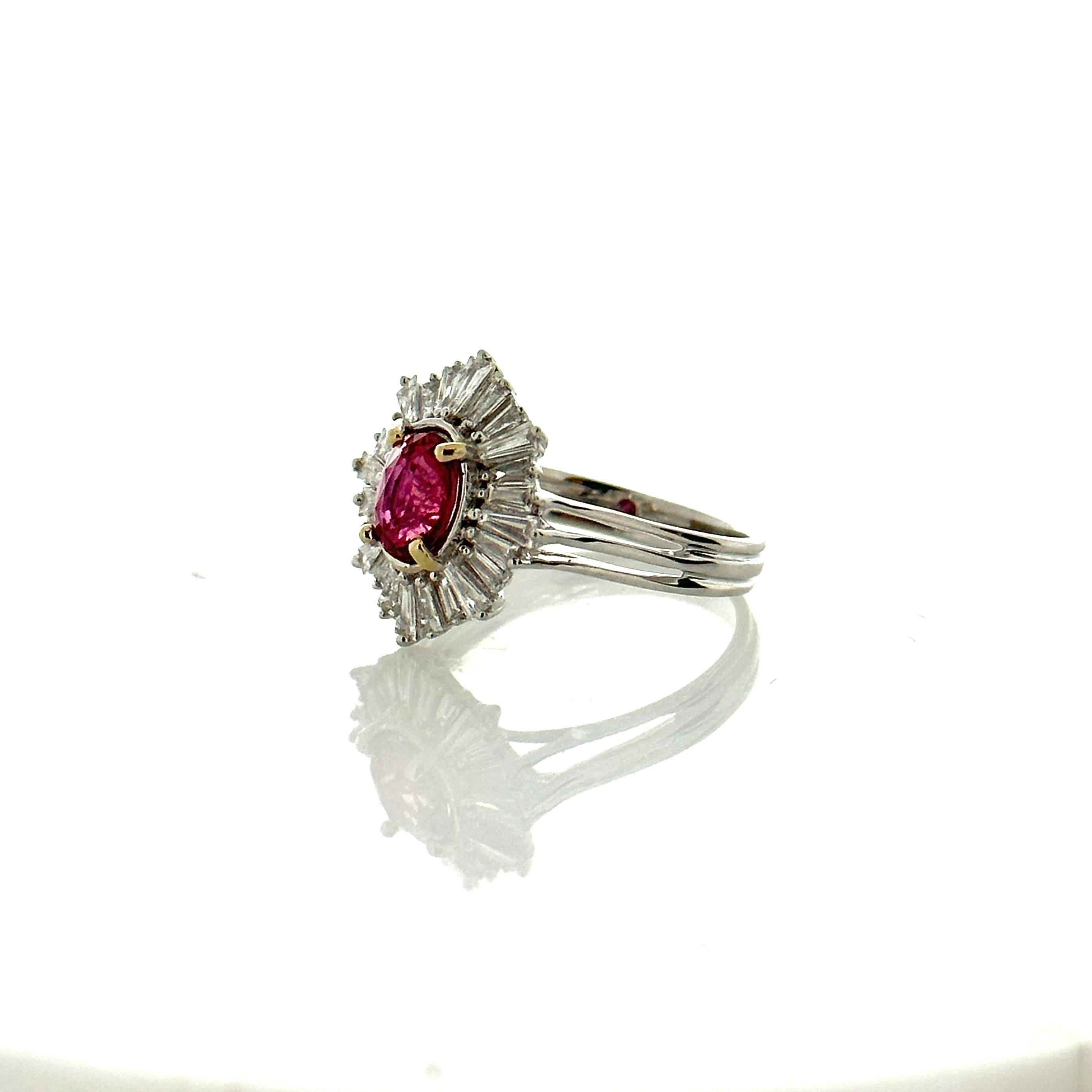 This is a cocktail ring featuring a 1.26 carat, oval brilliant, red ruby. The gem source is Myanmar. Its color is blood red with no modifier colors. Its transparency and luster are superb. The vibrant red is complemented by a dazzling display of
