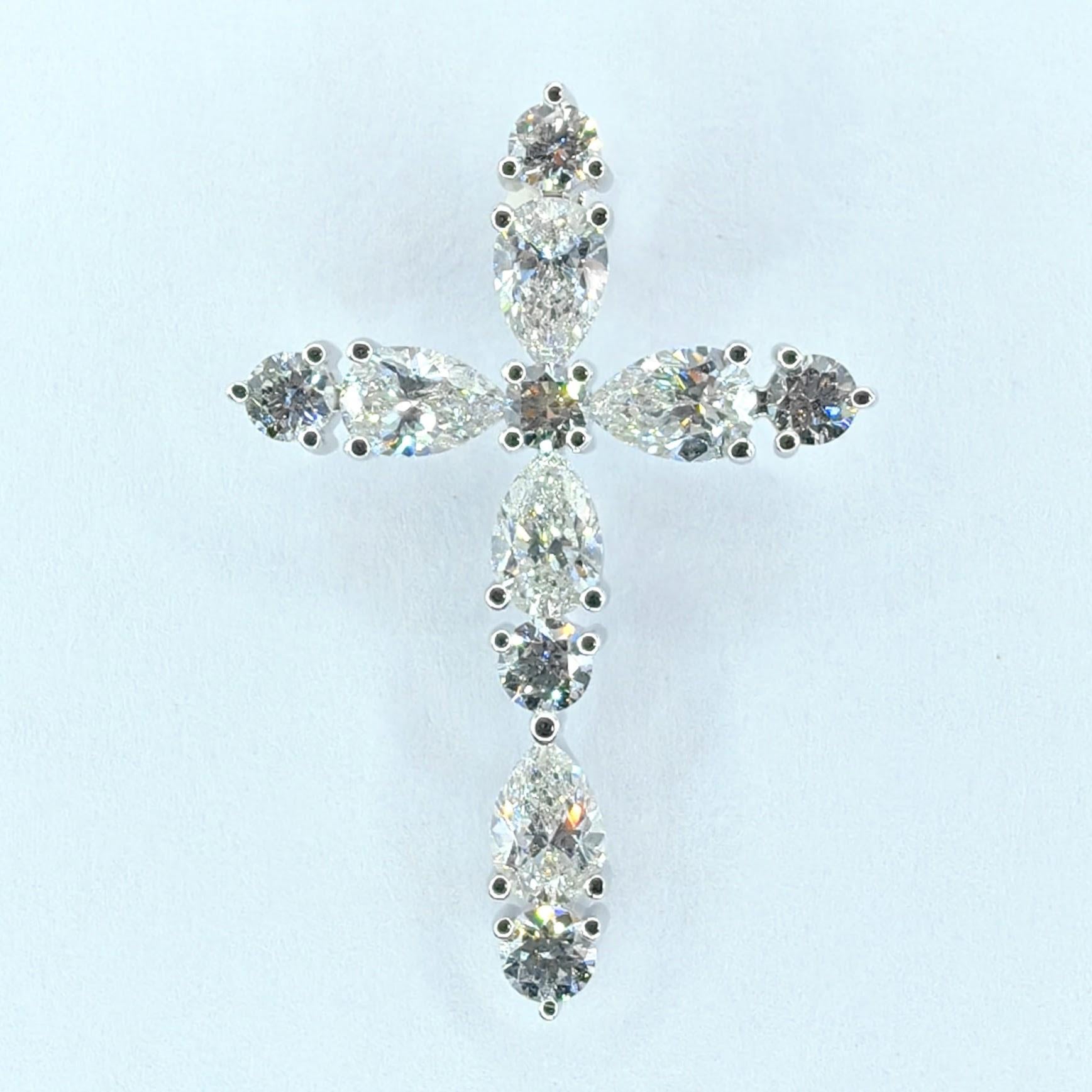 Voici un exquis pendentif croix en or blanc 18 carats de 1,26 carat en forme de poire et diamant rond taillé en brillant, où le symbolisme intemporel rencontre l'élégance contemporaine. Cette pièce réalisée de main de maître présente une combinaison