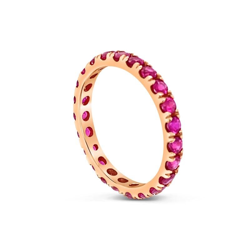 This eternity band features 1.26 carat total weight in natural pink sapphires set in 14 karat rose gold. It is a size 6. This band can be worn alone or stacked with other bands for a unique look.  If you would like to purchase in a particular size,