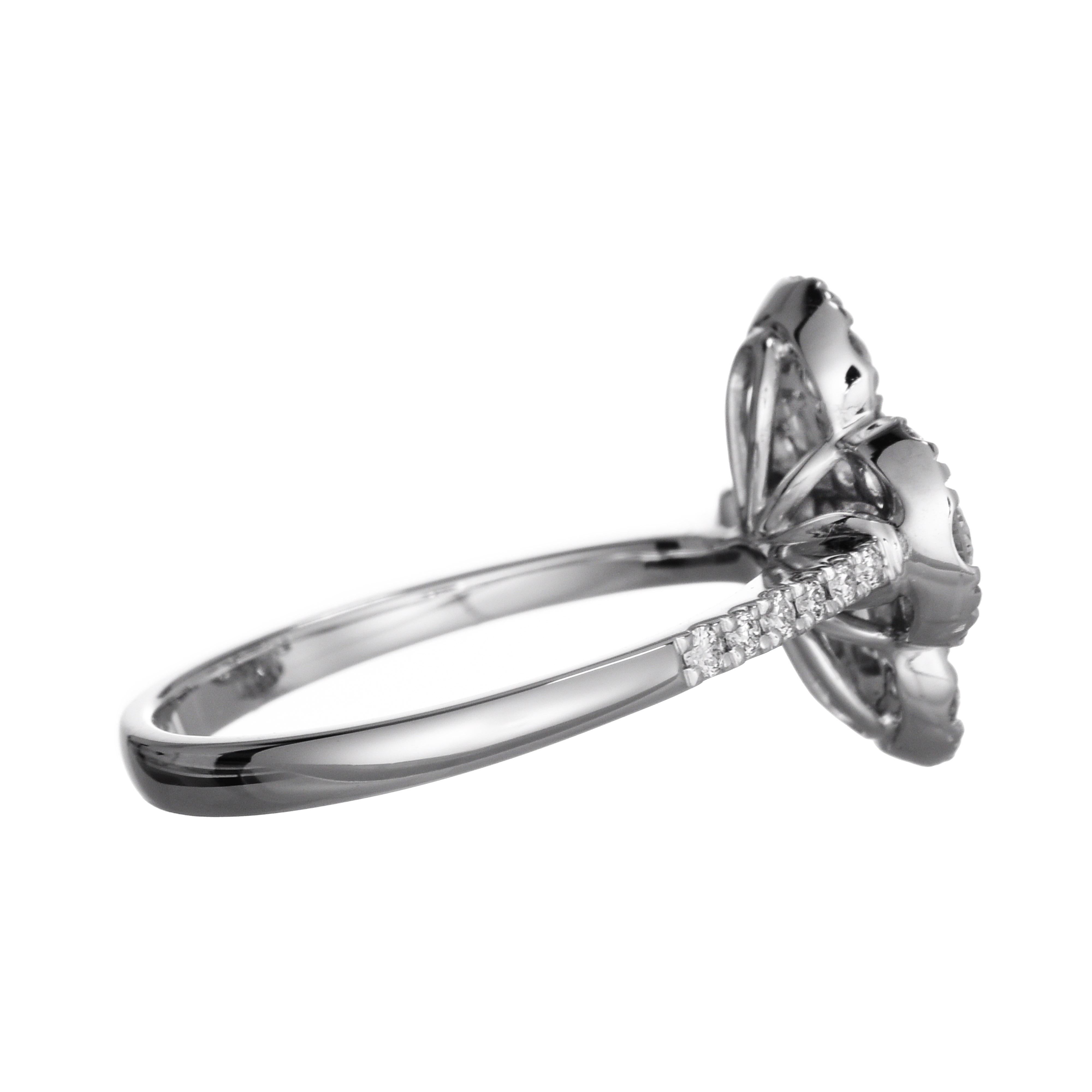 Cette magnifique bague met en valeur quatre diamants de taille baguette avec un diamant de taille ronde au centre, formant une forme 