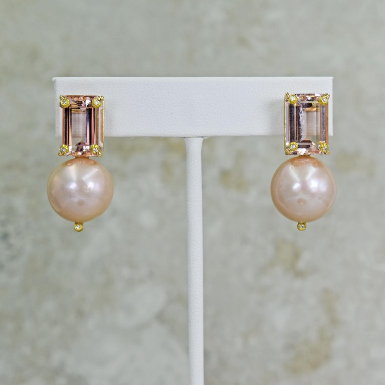 12.61 total carat emerald shaped Morganite, accent Diamond and round, freshwater pink Pearl 14k yellow gold stud drop earrings. Stud earrings are 1.25 inches in length.