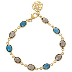 12.62 Carat Blue Topaz and Smoky Quartz 18 Karat Yellow Gold Bracelet