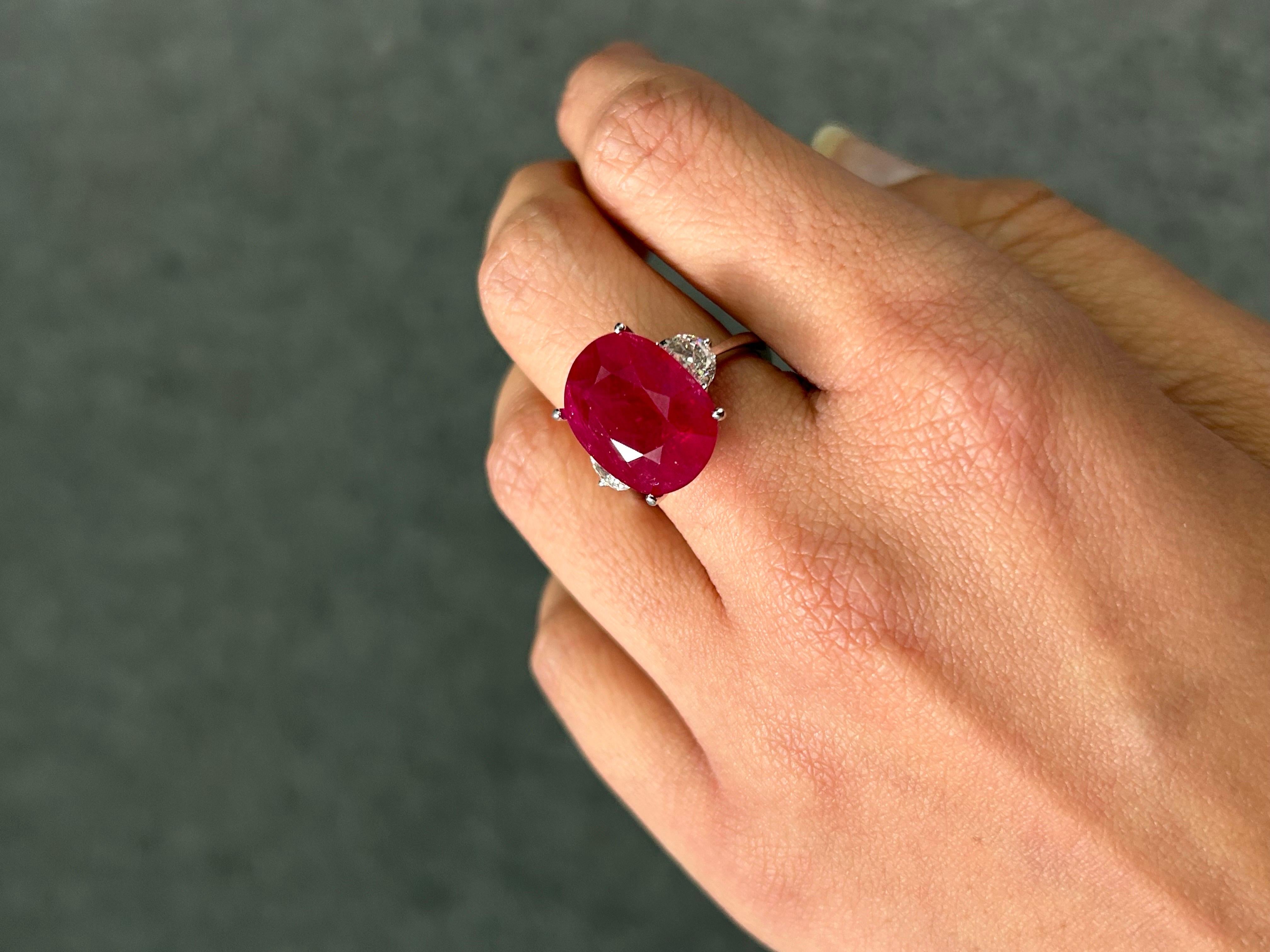 A statement 12.68 certified Burma Ruby ring,  adorned with VS quality, white half moon diamonds all set in solid 18K white gold. Currently sized at US 7, can be resized. 
Please feel free to message us for more information. 
We provide free
