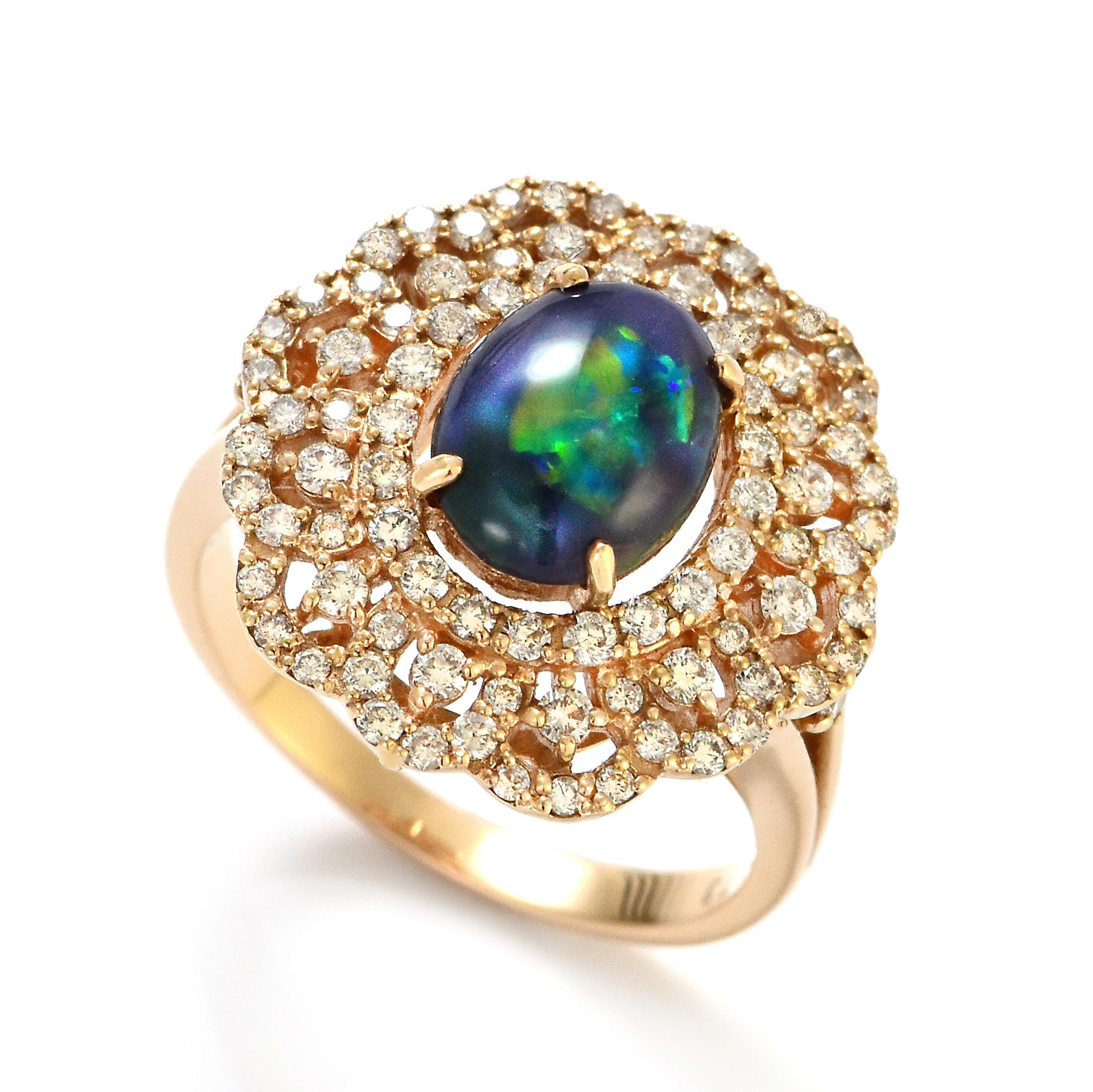 A beautiful ring featuring a 1.27 Carat, Natural, Australian Black Opal and 0.72 Carats of Diamond Accents set in 18K Pink Gold. The Opal displays very good play of color! Opals are known for exhibiting flashes of rainbow colors known as 