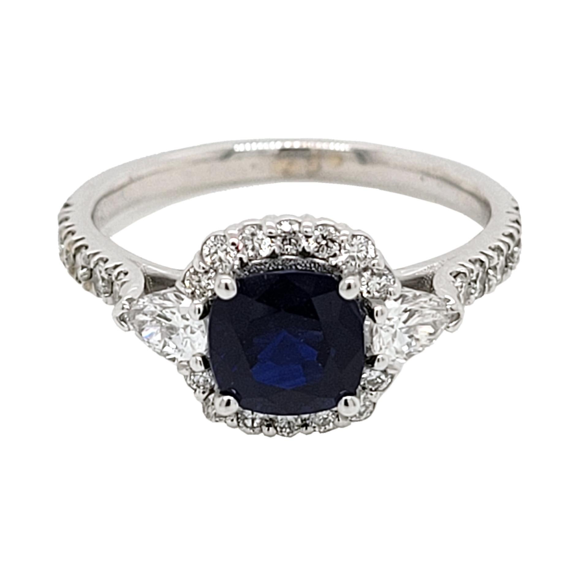 A  Beautiful Color 1.30 Ct Cushion Shaped Sapphire set in a gorgeous 18k gold  Pave set engagement Ring with halo and two pear shape diamonds on the side. Total diamond weight of 0.64 Ct. diamonds on the side. 

Center stone: 1.27 Ct Cushion Shape