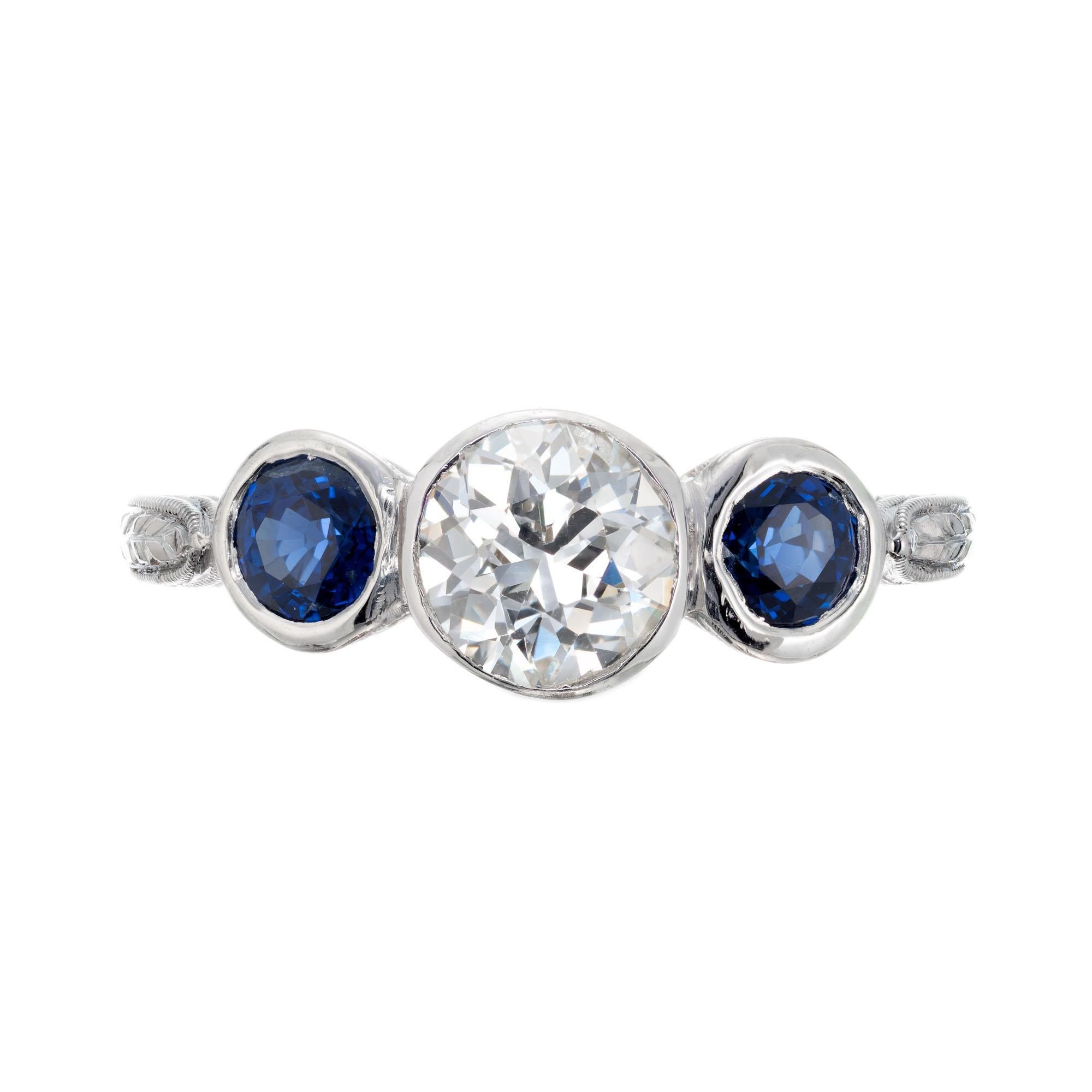 1920’s Art Deco diamond and sapphire engagement ring. EGL certified Old European cut diamond with two round sapphires in a three-stone hand pierced, engraved platinum setting. 

1 old European cut diamond, approx. total weight .77cts  H – I, SI3.