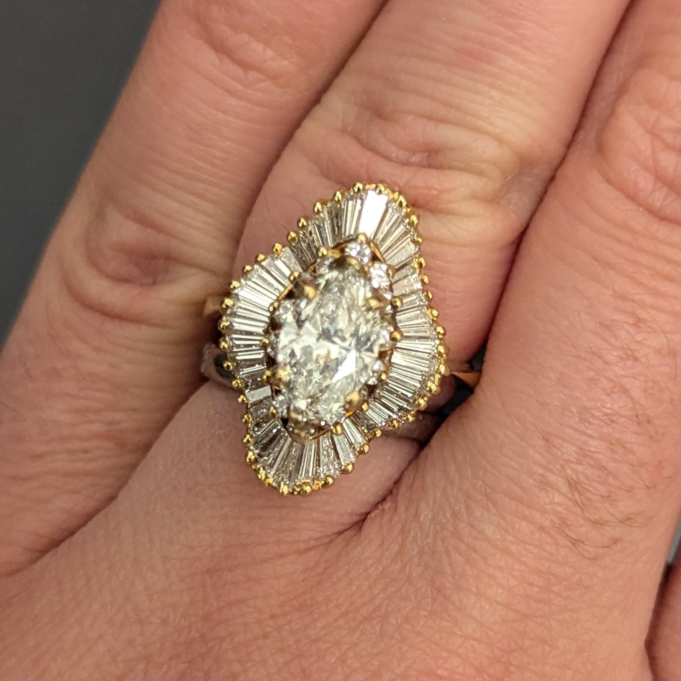 This ring features one centering marquise-shaped diamond, weighing approximately 1.27 carats, surrounded by 14 round and 40 baguette diamonds, weighing approximately 1.30 carats.