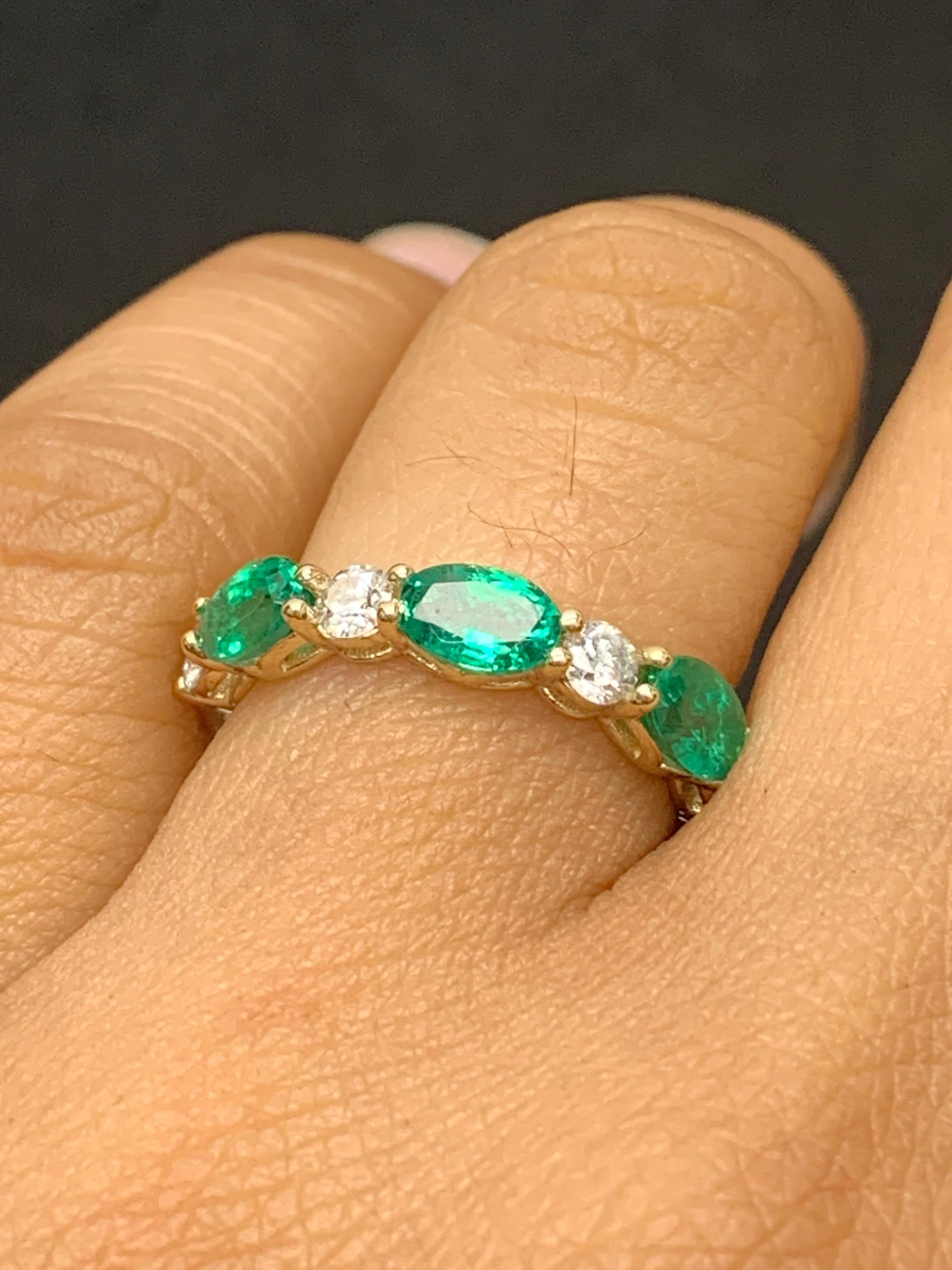 Handcrafted to perfection; showcasing color-rich oval cut emeralds that elegantly alternate round diamonds in a 14k Yellow gold setting. 
The 3 emeralds weigh 1.27 carats total and 4 diamonds weigh 0.61 carats total.

Size 6.5 US (Sizable). One of a