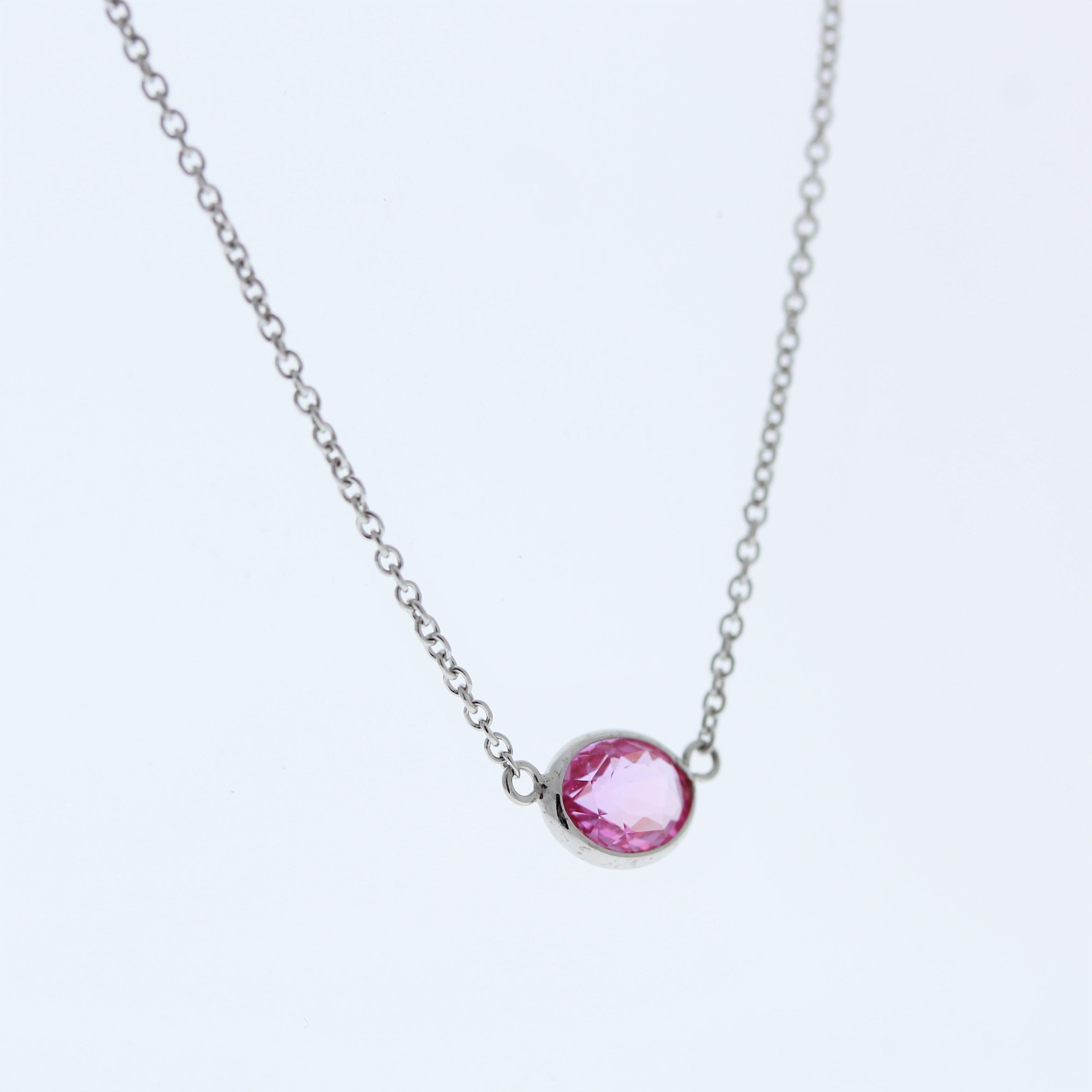 It sounds like you're describing a fashionable necklace featuring an oval-shaped Padparadscha gemstone weighing 1.27 carats, set in a 14 karat white gold pendant or setting. The gemstone's pinkish-orange hues would likely make for a striking and