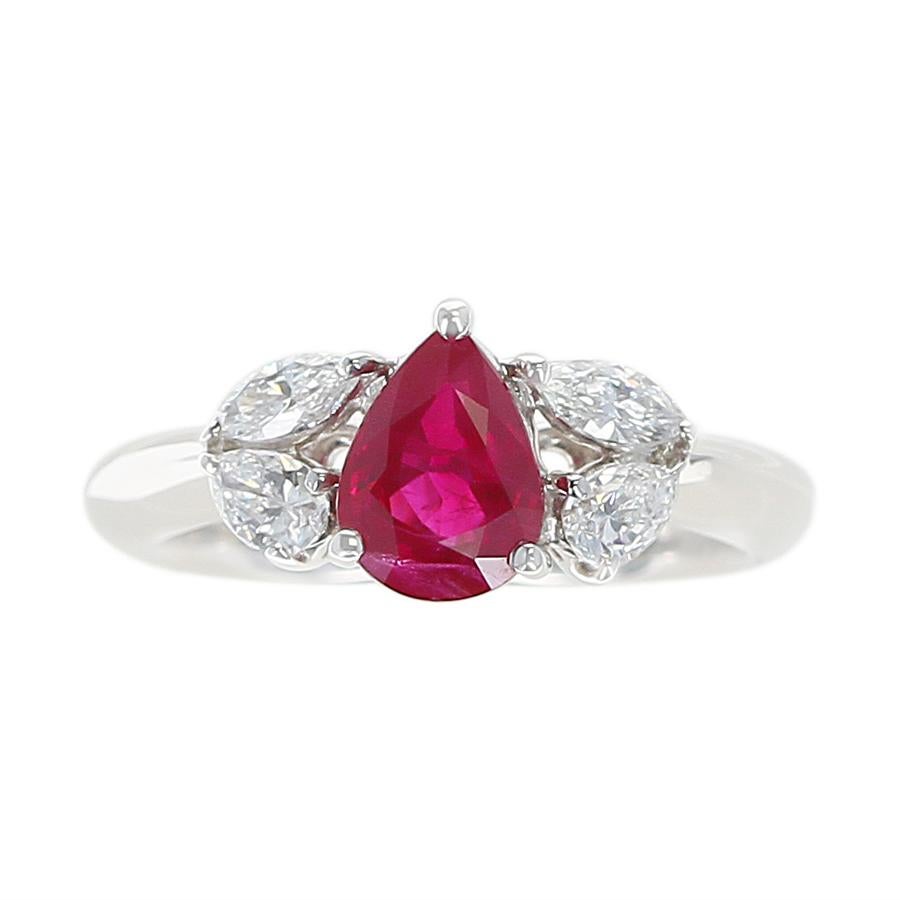 A 1.27 Carat Pear Shape Ruby and Diamond Three Stone Engagement Ring in Platinum. Ruby Weight: 1.27 carats, Diamond Weight: 0.45 carats. Ring Size US 5.50. Total Weight: 6.04 grams.