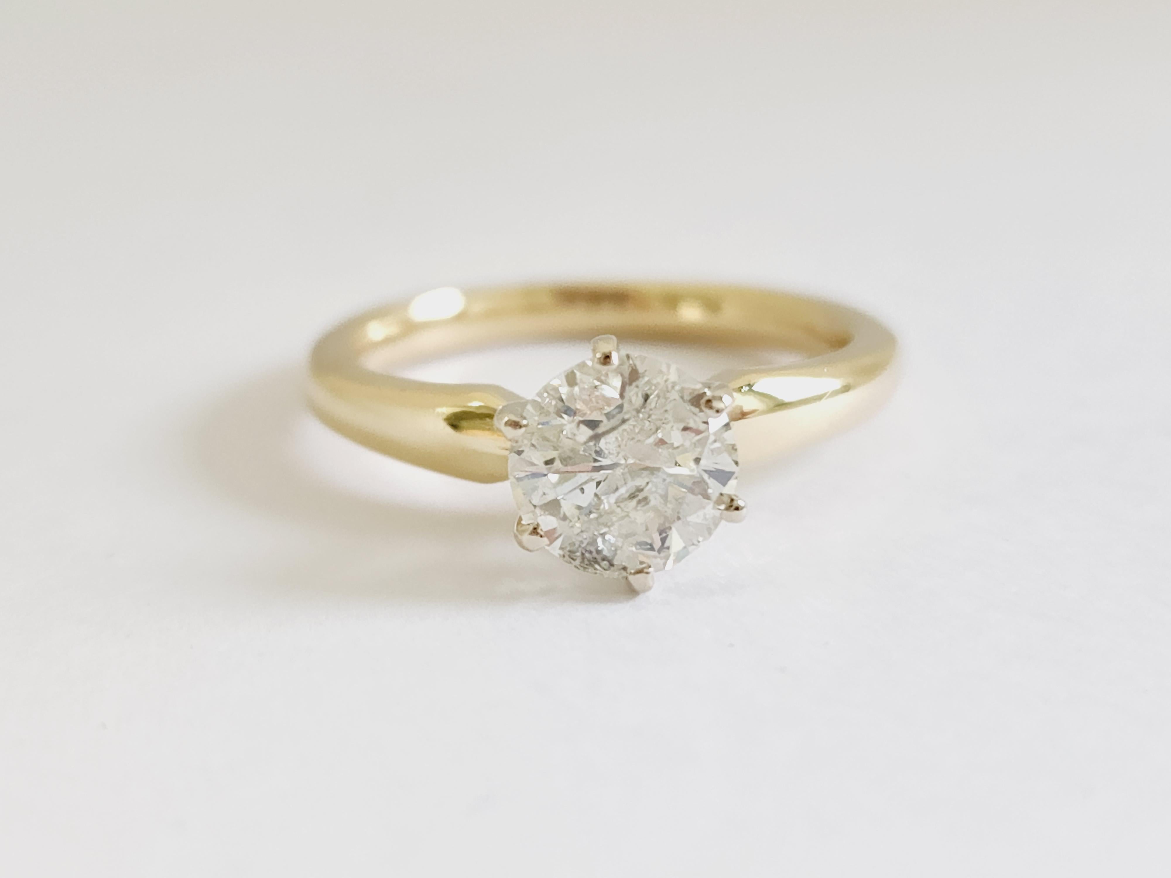 1.27 ct round brilliant cut natural diamonds. 6 prong solitaire setting, set in 14k yellow gold. Ring Size 6.5.