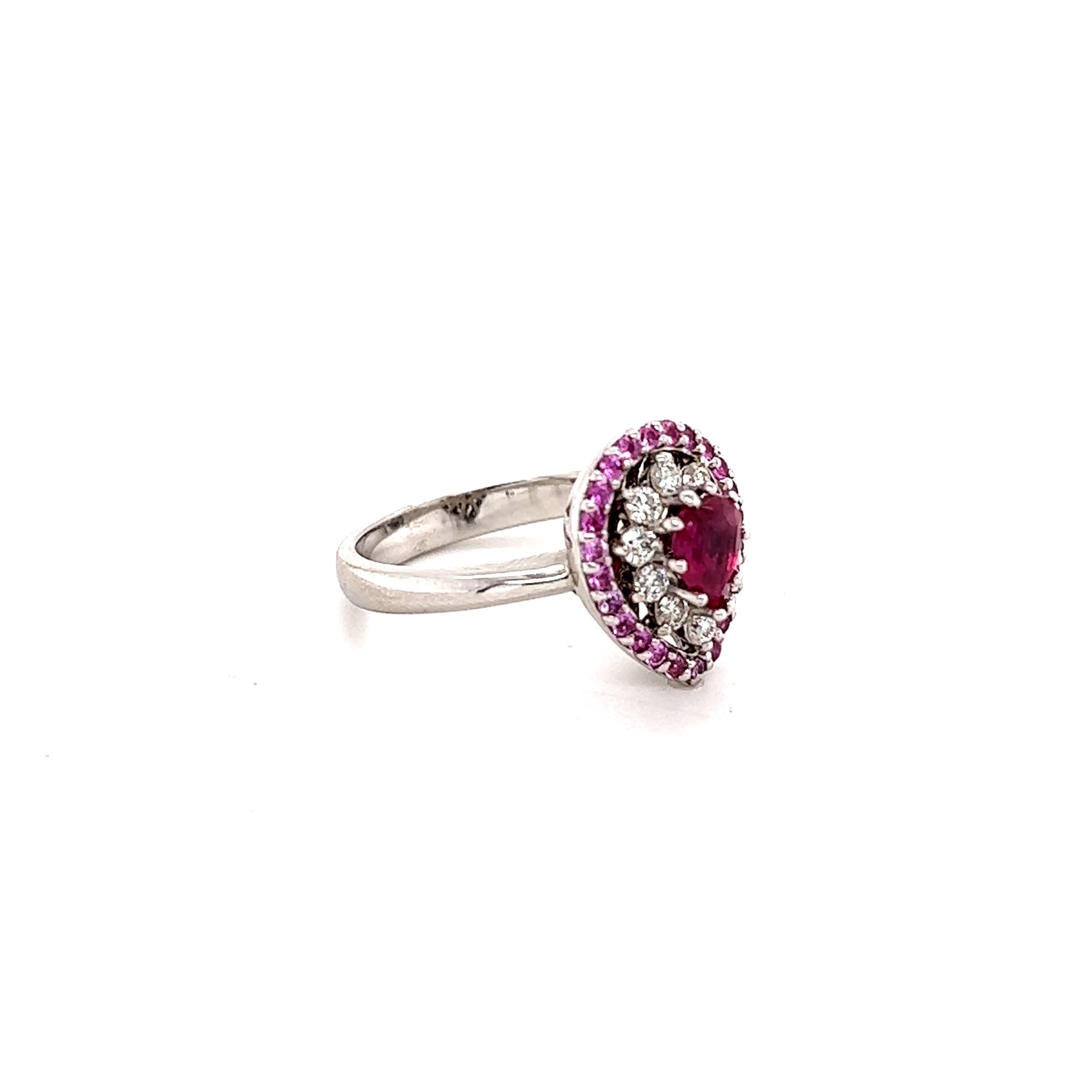 This ring has a Pear Cut Ruby that measures at approximately 6 mm x 4 mm. It also has 24 Round Cut Pink Sapphires that weigh 0.37 carats and there are 10 Round Cut Diamonds that weigh 0.28 carats. (Clarity: VS, Color: H) The total carat weight of