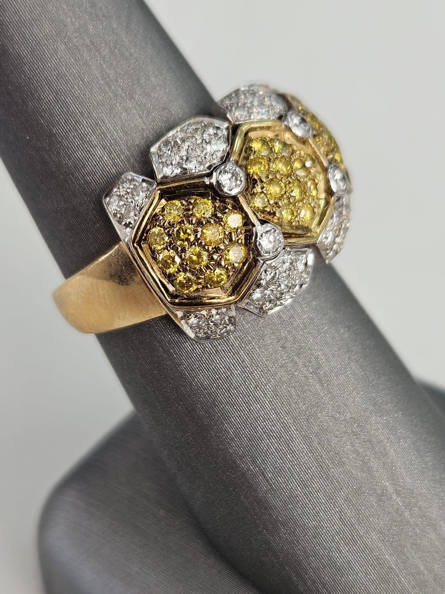 An enchanting 1.27 carat Canary Diamond band ring that marries the warmth of yellow diamonds with the timeless sparkle of white diamonds, forming a captivating pattern of hexagons. At the heart of this exquisite piece is a radiant 0.60-carat Canary
