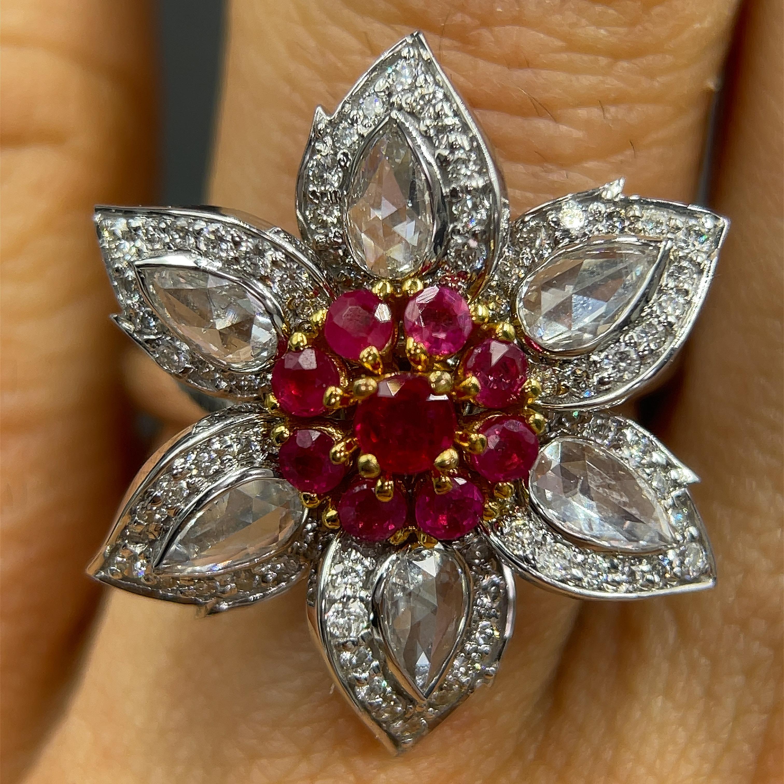 A life like rendition of the magnolia flower, this ring features 0.71 carats of natural Burmese rubies flanked by rose cut diamonds.
Round Brilliant & Rosecut Diamonds
Shape	Rose cut
Color	F
Clarity	VVS
Weight	0.71 carats
Additional Diamonds