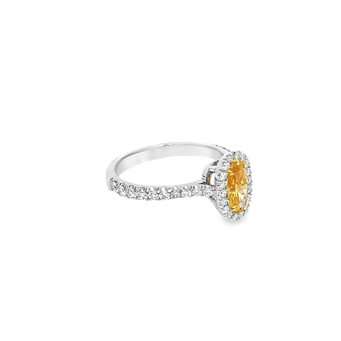 This stunning piece of jewelry showcases a natural, Fancy Vivid Yellow-Orange diamond that weighs 0.62 carats and is GIA-certified with SI2 clarity and even color distribution. The diamond is a one-of-a-kind masterpiece and bears the unique