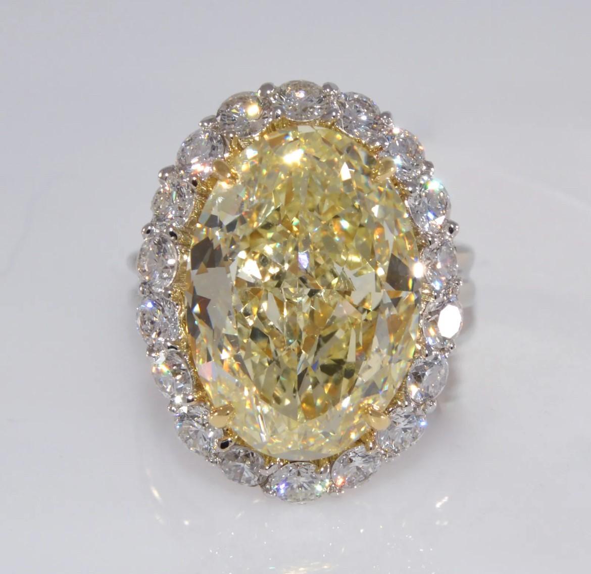 Oval Cut 12.71 carat GIA Canary Yellow Oval Diamond with Diamond Halo Ring For Sale