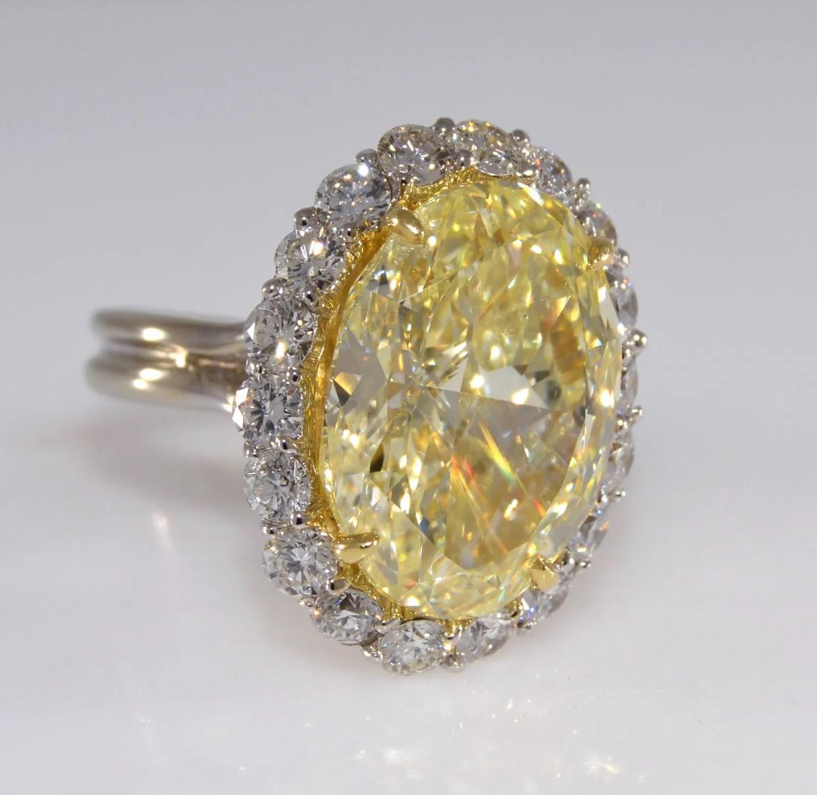 Women's or Men's 12.71 carat GIA Canary Yellow Oval Diamond with Diamond Halo Ring For Sale