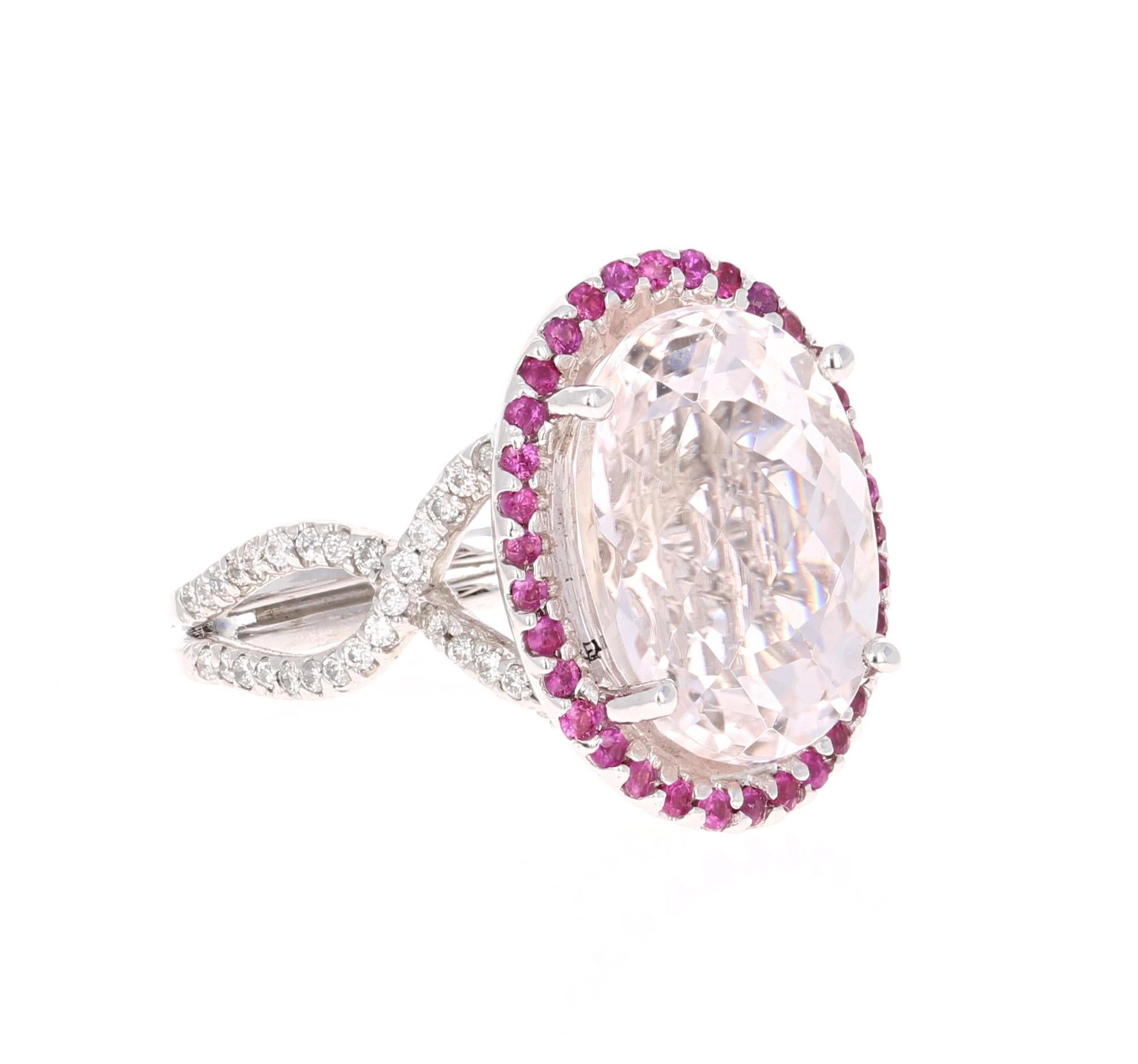 This beautiful ring has a huge Oval Cut 11.73 Carat Kunzite that is set in the center of the ring and is surrounded by 34 Round Cut Pink Sapphires that weigh 0.40 carat. This ring also has 94 Round Cut Diamonds that weigh 0.61 Carats and are set