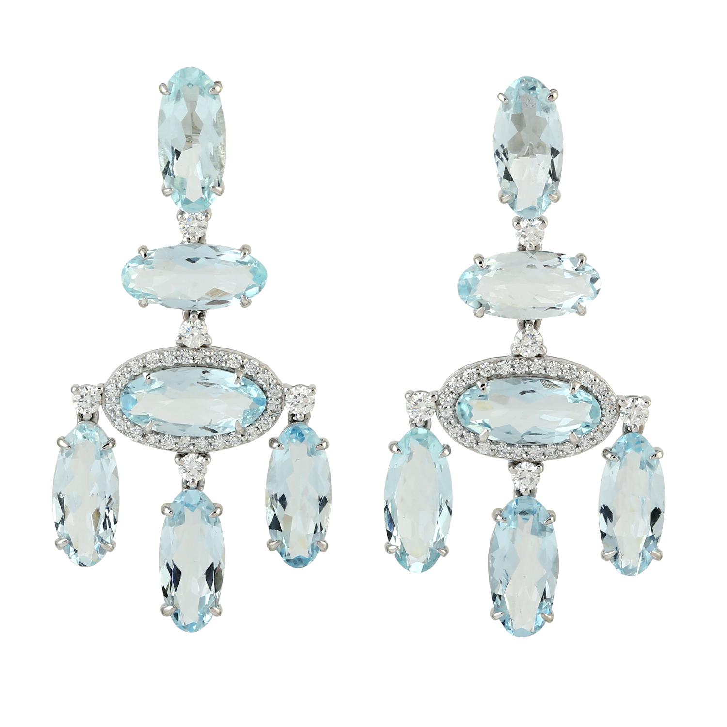 Cast in 14 karat gold, these exquisite earrings are hand set with 12.77 carats blue topaz and .74 carats of glimmering diamonds. 

FOLLOW MEGHNA JEWELS storefront to view the latest collection & exclusive pieces. Meghna Jewels is proudly rated as a