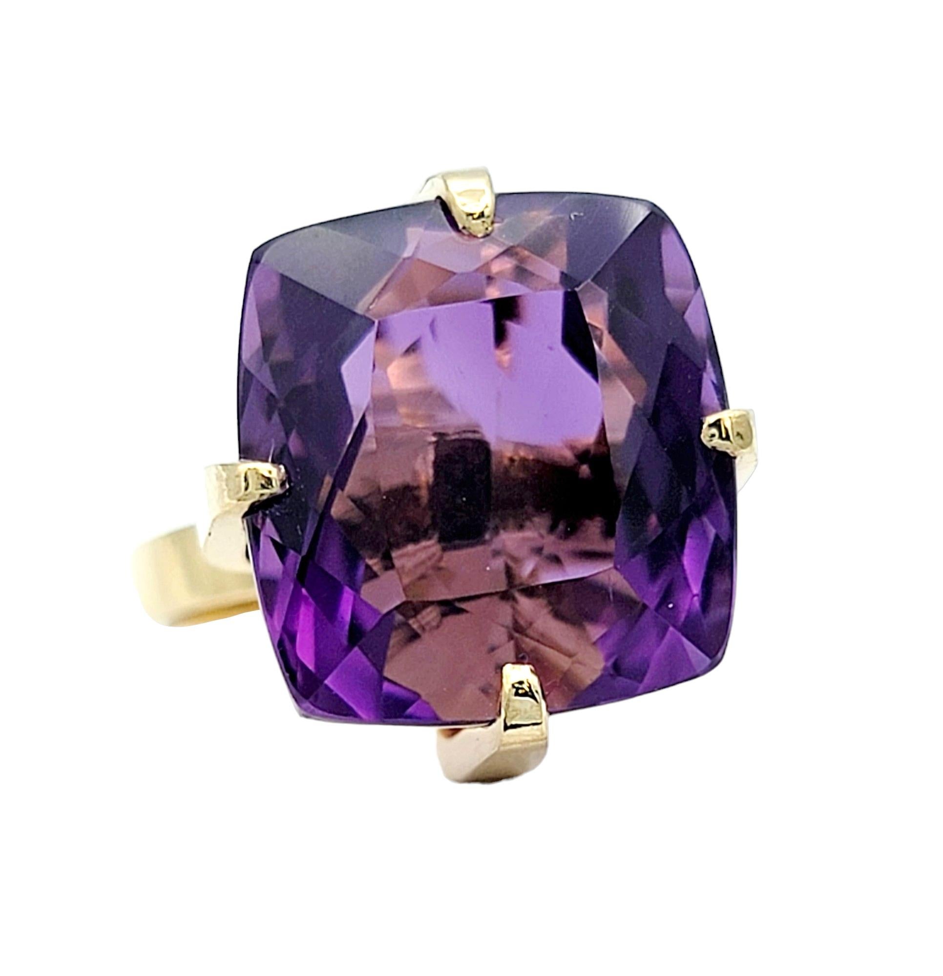 Ring Size: 5.75

This captivating high profile ring radiates regal allure, featuring a substantial cushion-cut amethyst, boasting a remarkable weight of 12.79 carats. Set in the warmth of 18 karat yellow gold, the deep purple hue of the amethyst