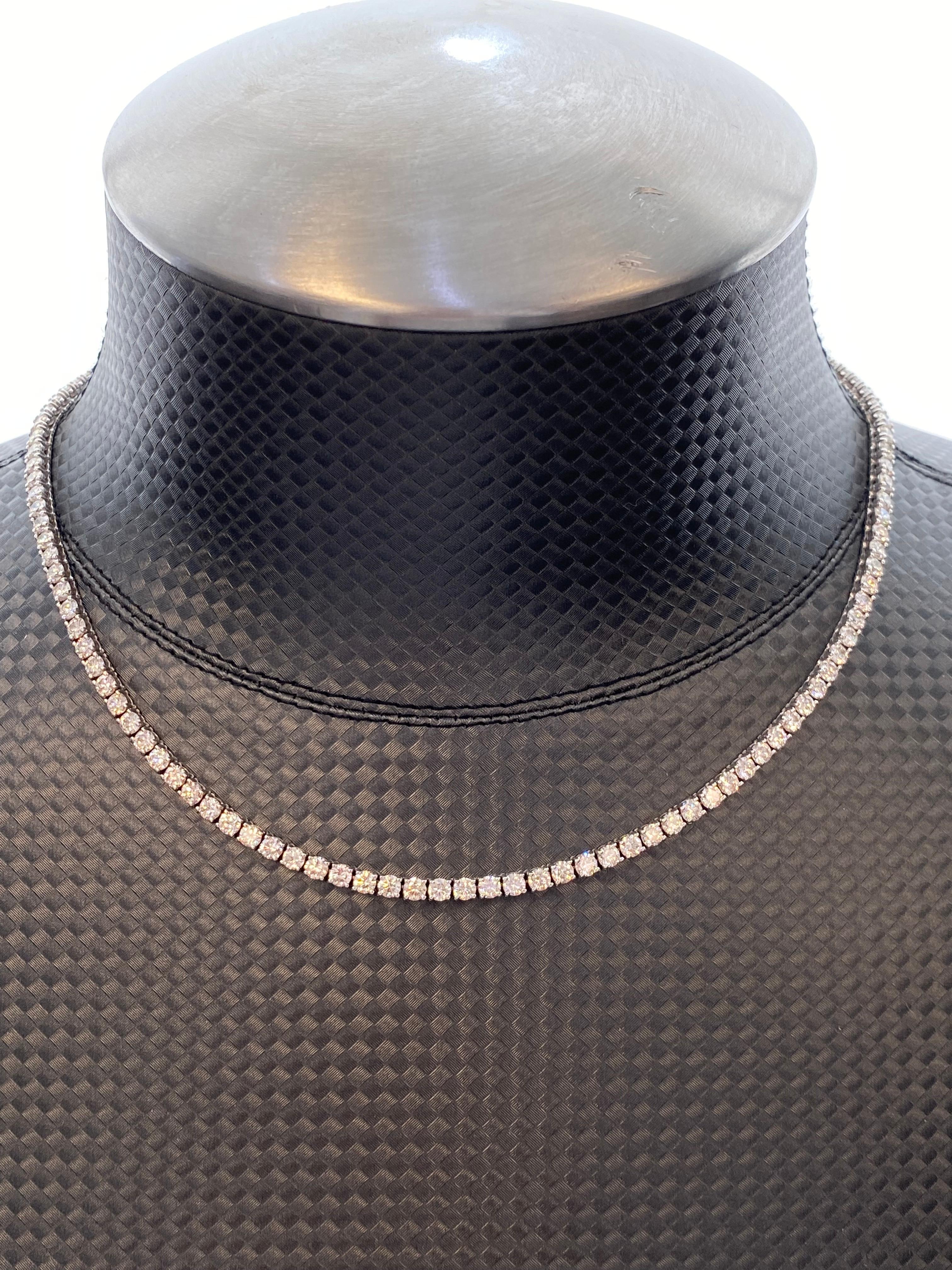 Exquisite and timeless diamonds tennis necklace. Made by Alexander of Beverly Hills.
127 round brilliant diamonds, 12.79 carats total. Approximately G/H color and SI clarity. Four prong set in 18k white gold.
Accommodated with an up to date