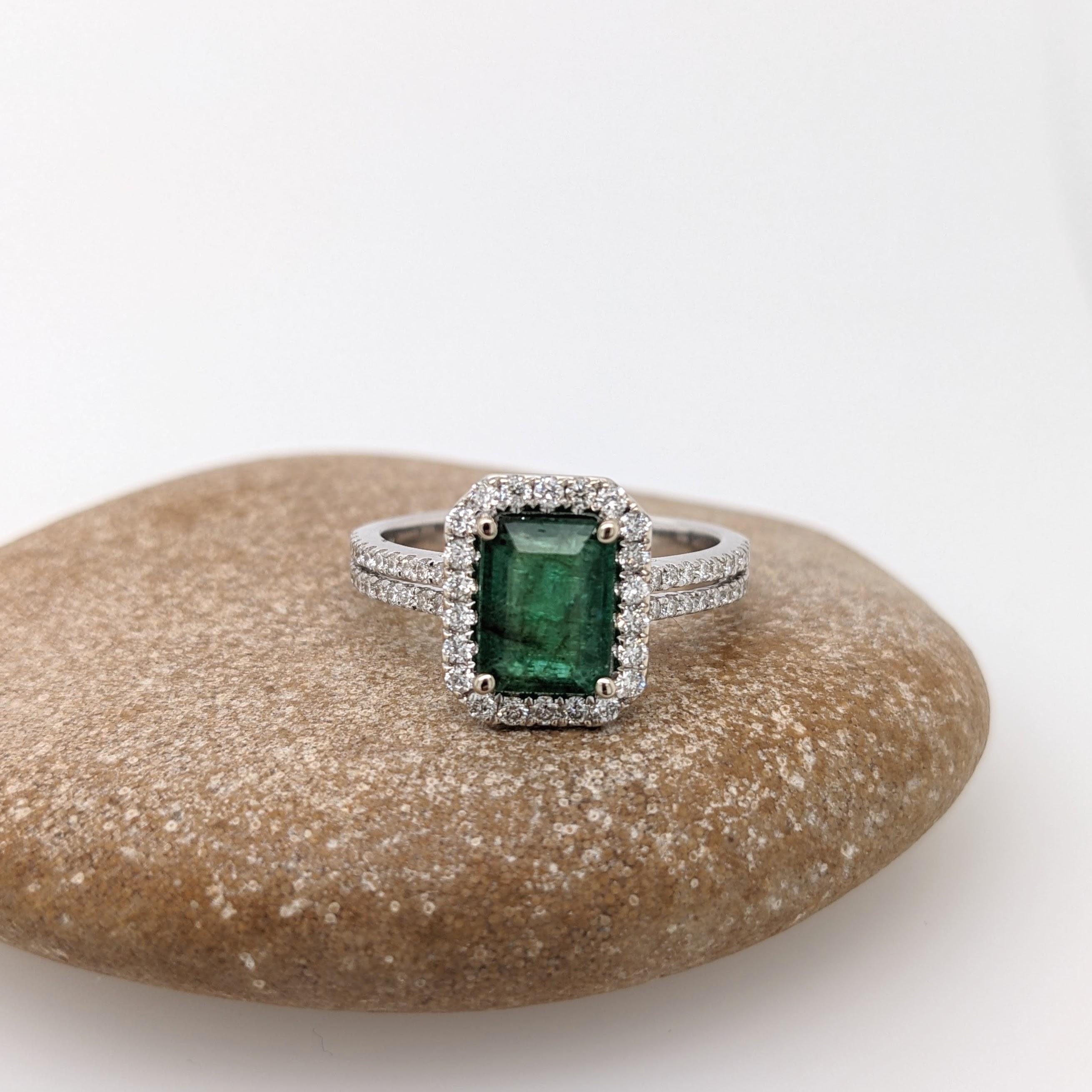 This ring features a beautiful emerald set in a split shank halo ring setting with sparkling natural diamonds all set in 14k solid white gold. A gorgeous modern look that's perfect for any special occasion!

Item Type: Ring
Center Stone: