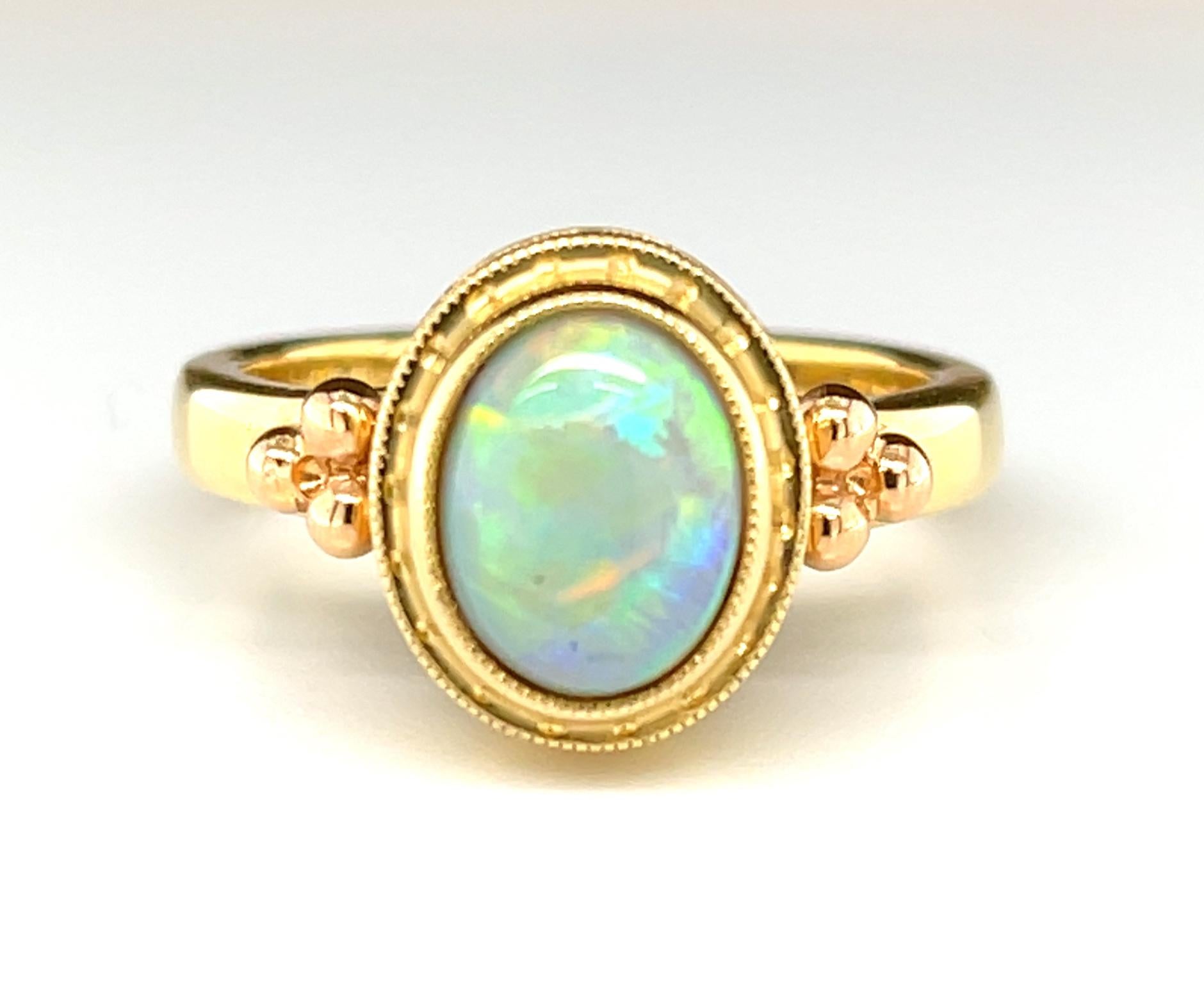 This rich black opal ring will add a touch of colorful elegance to every day! Featuring a 1.28 carat opal with beautiful play-of-color, this chic and sophisticated ring was handmade in 18k yellow gold by our Master Jewelers in Los Angeles using