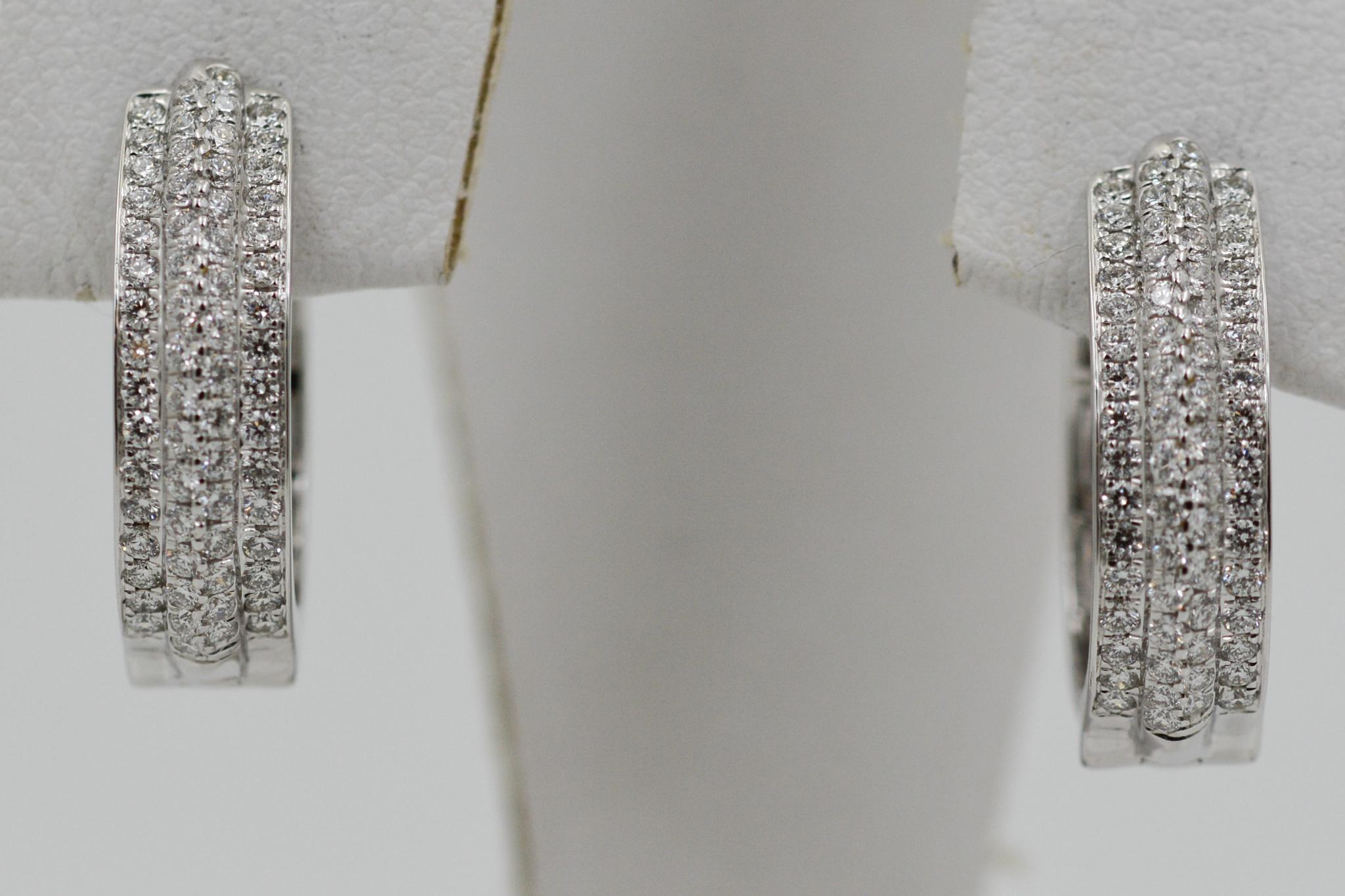These 14 karat white gold hoop earrings feature 128 round brilliant cut diamonds weighing an approximate combined 1.28 carats with G coloring and VS clarity. 