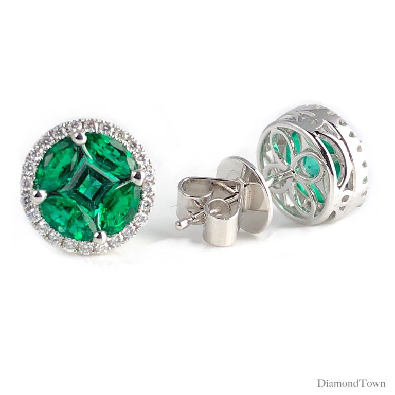 Gorgeous round emerald stud earrings feature a cluster center of bright green emeralds (total weight 1.28 carats), surrounded by a halo of round white diamonds (total weight 0.22 carats).

Set in 18k White Gold. DiamondTown is proud to produce this