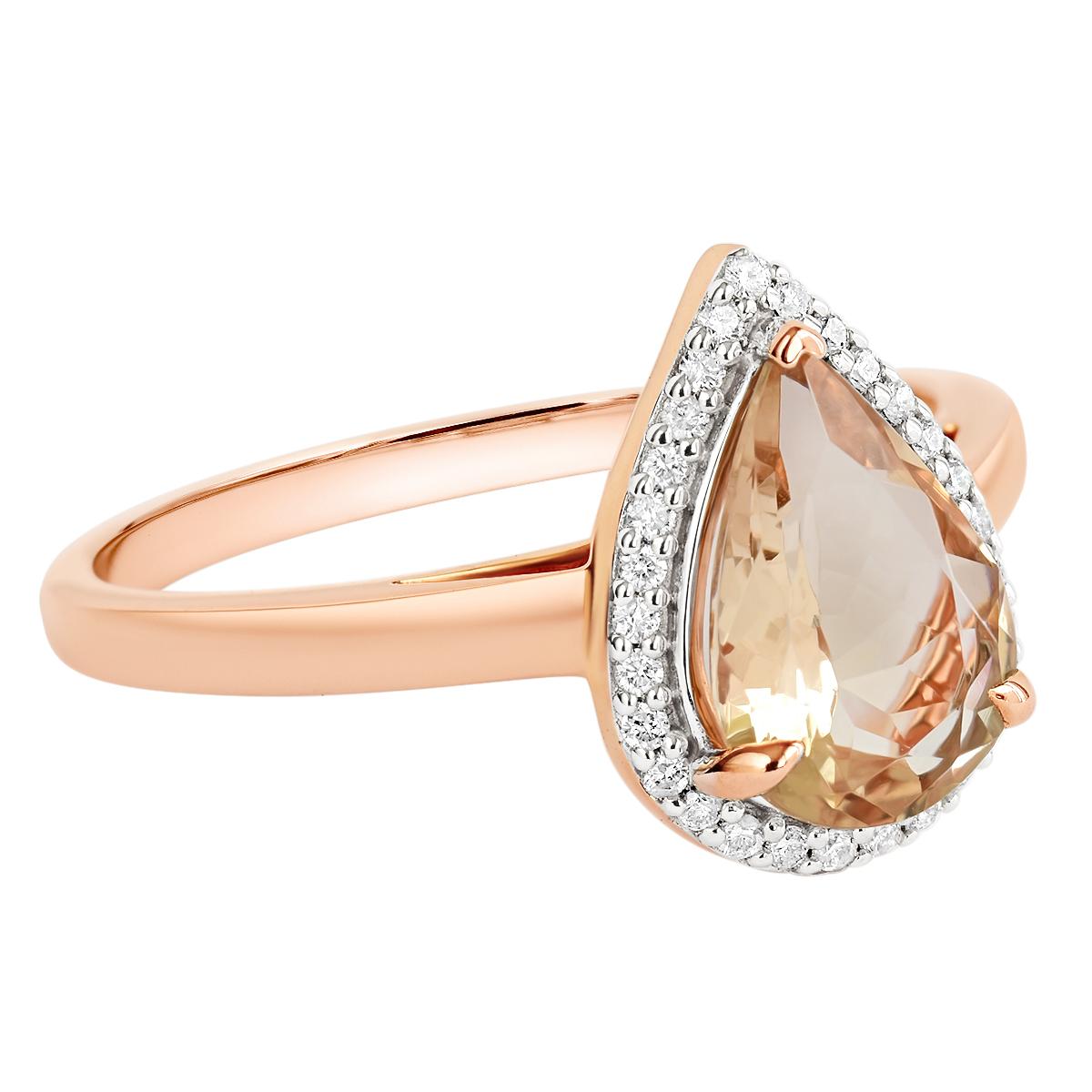 A beautifully crafted solid 9K rose gold ring featuring a 1.28 carat morganite adorned with 29 diamonds in an alluring halo setting. The morganite is natural and earth mined and is an eye pleasing pastel peach in colour with flashes of pink visible