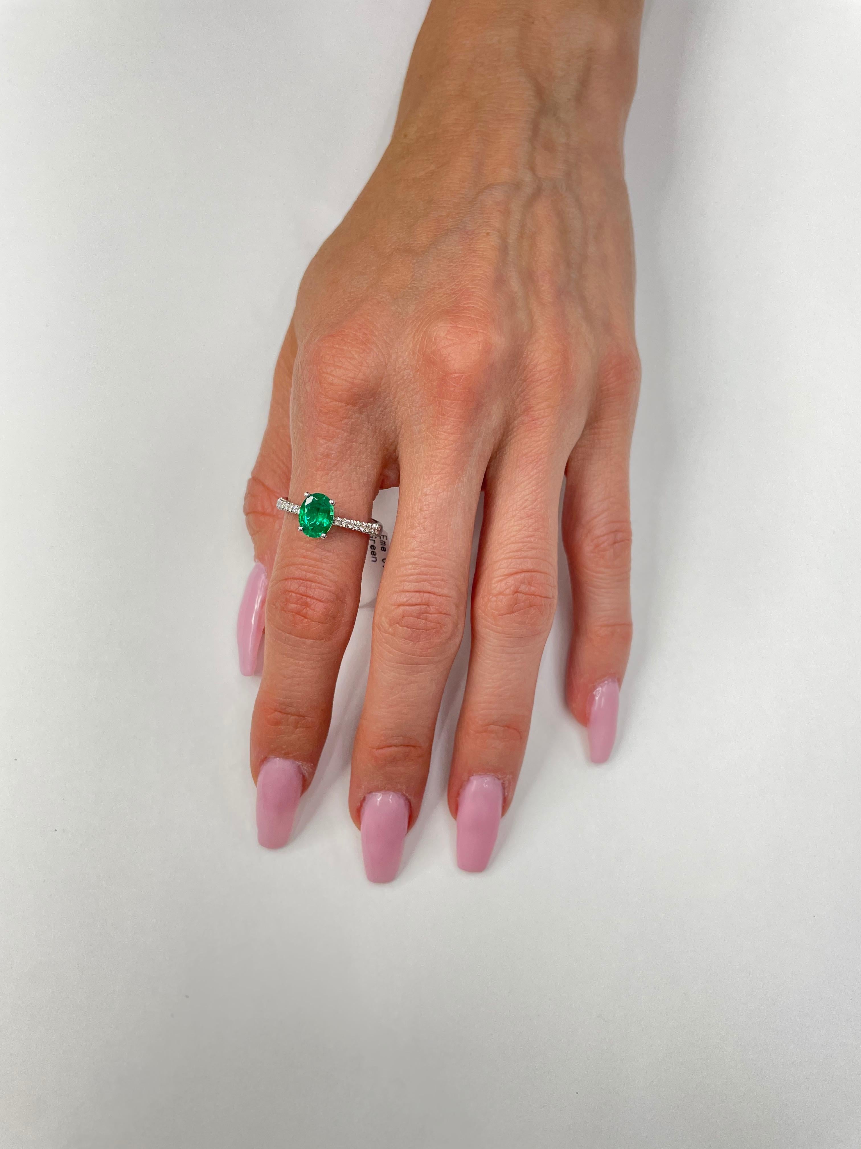 This sweet 1.28ct Oval Cut Green Emerald and diamond is set in 18K white gold + 0.15cttw Diamonds