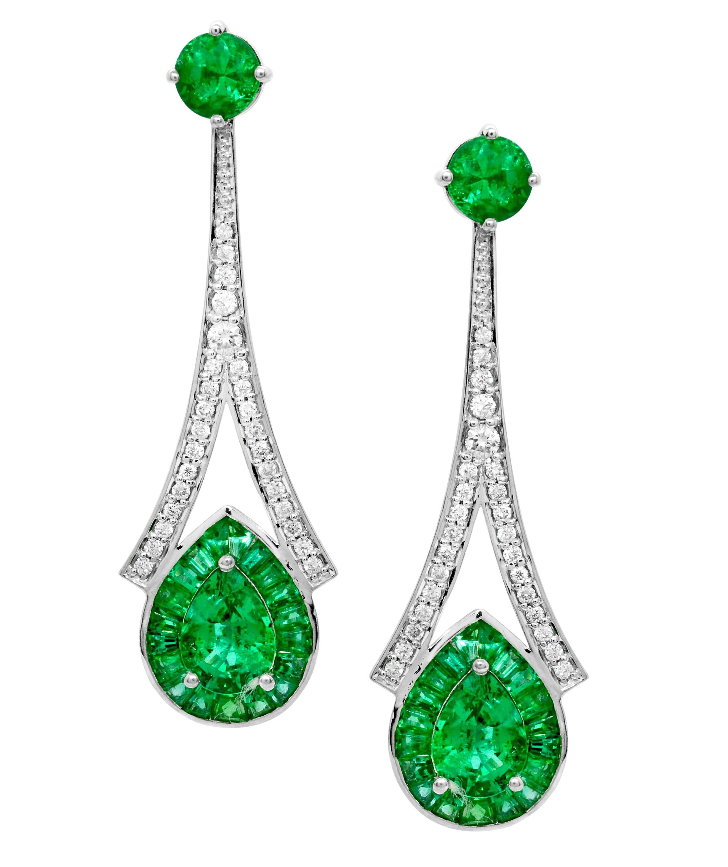 Intensely green emeralds.  These stunning drop earrings have a 1.28 carat total weight of pear-shaped emerald set at the center, with baguette emeralds of varying sizes weighing 1.80 carat total weight.  The round emeralds at the top are 4.50 mm