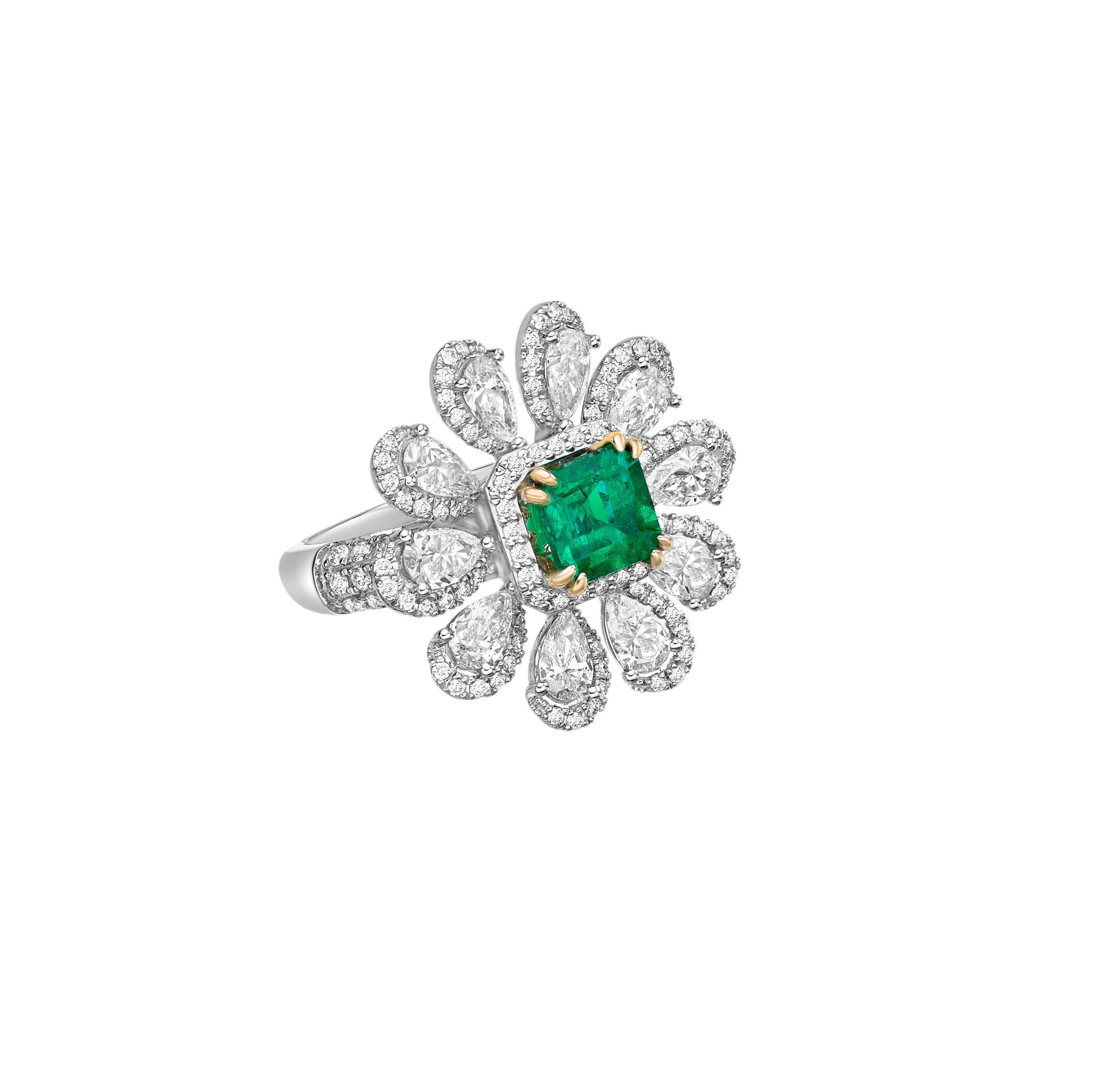 Sunflower Emeralds by Sunita Nahata Fine Design. This collection showcases brilliant green emeralds set on a bed of beautiful white diamonds set in white yellow gold. This is a small and delicate bridal ring that yet emanates glamour and