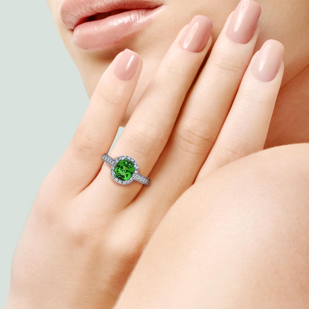 The vibrant green of this Tsavorite Garnet rivals the color of a Columbian Emerald set into this 18K white gold diamond ring.

Hallmarks: 750, SC, 1.28, DO .28

Center Gemstone
Gemstone: Tsavorite Garnet
Carat Weight: 1.28 ct
Shape: Oval
Gemstone