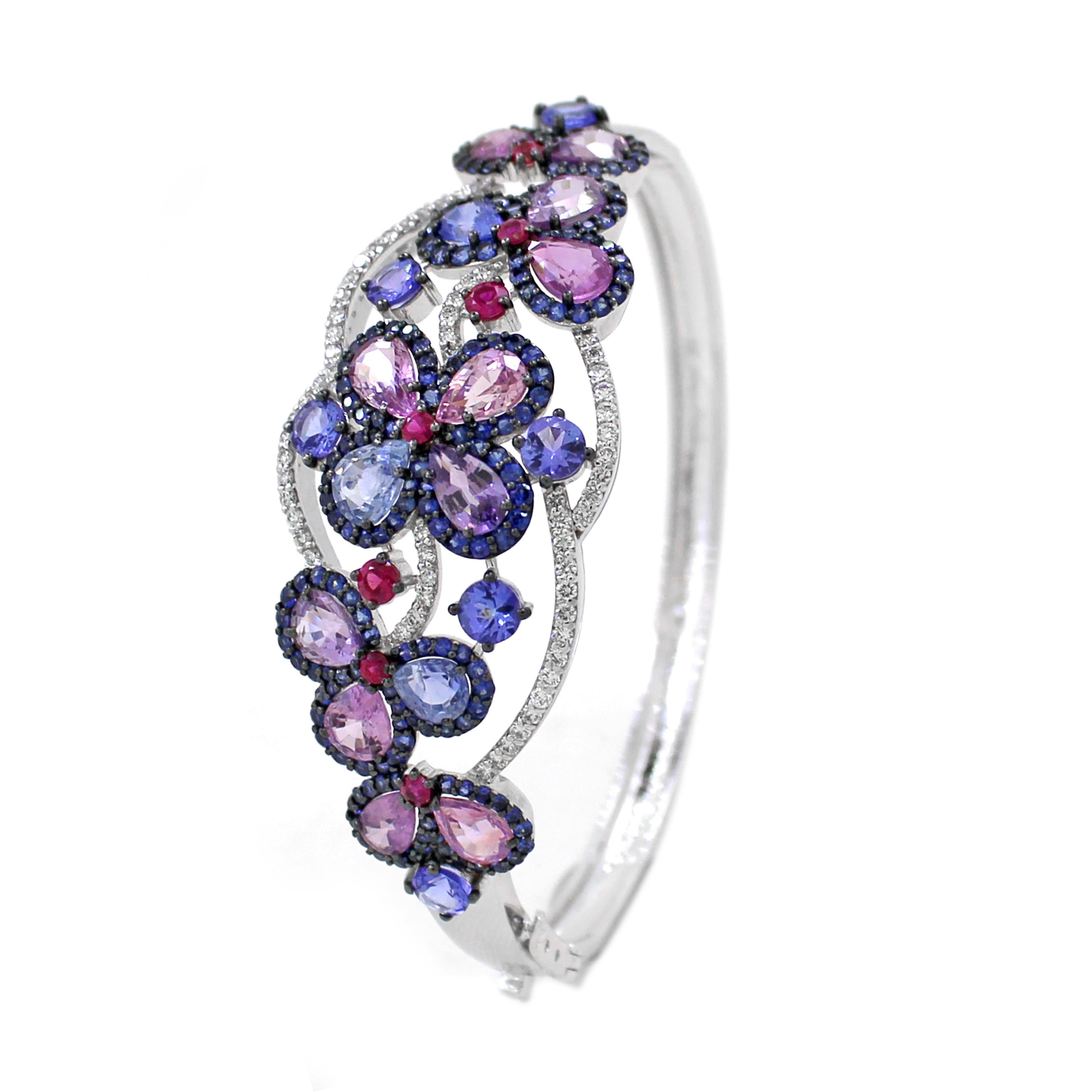 This exceptionally beautiful cuff bracelet, inspired by the splendor of nature, showcases a breathtaking array of colors that play a vital role in its design. Crafted in 18k white gold and weighing 21.5 grams, this piece is a true masterpiece. It
