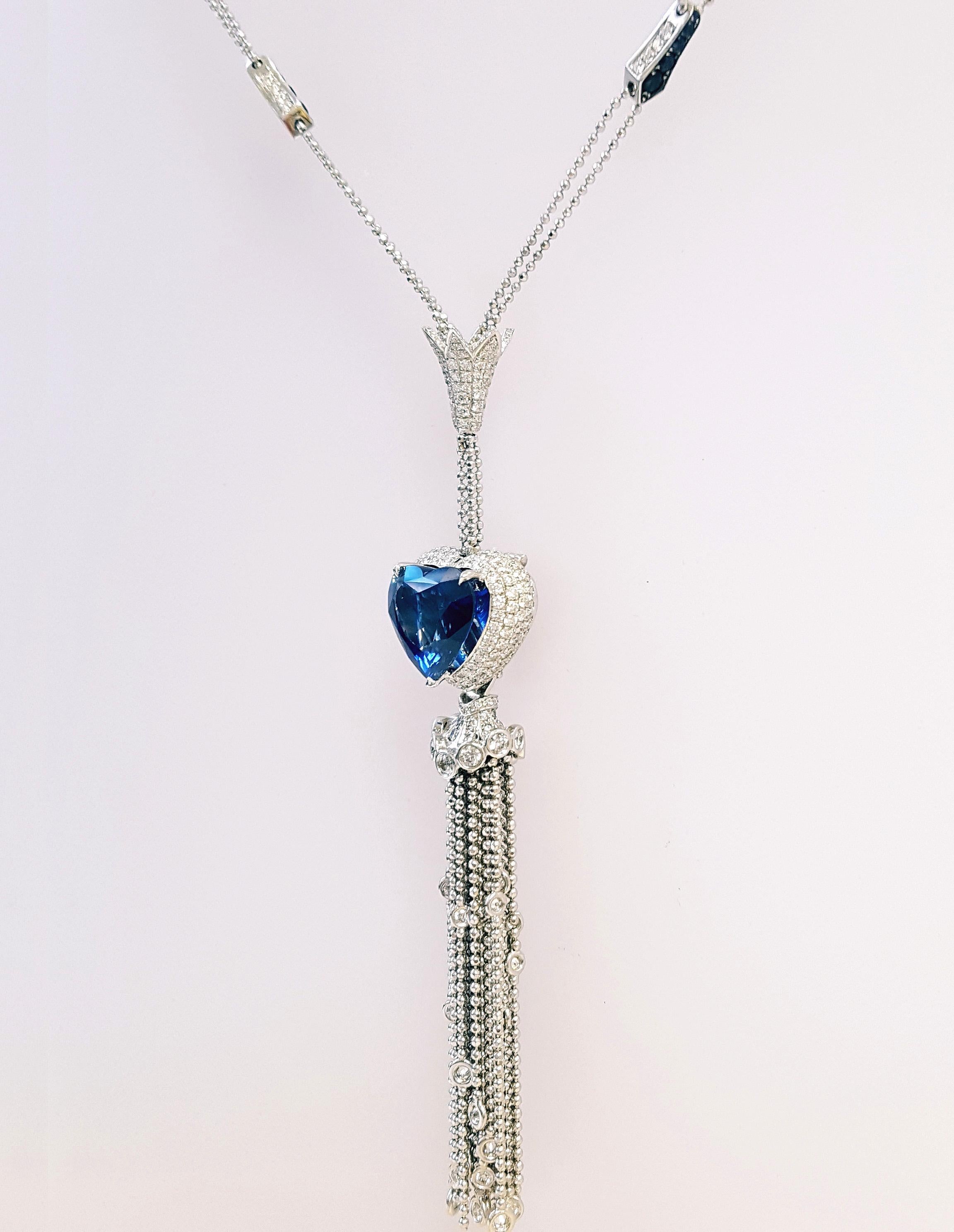 Introducing a Breathtaking Art Deco-Inspired Necklace. It features a gorgeous heart-shaped sapphire, just under 9 carats, certified by GRS as a natural gem of Madagascar origin. The center stone is elegantly encircled by a halo of dazzling diamonds,