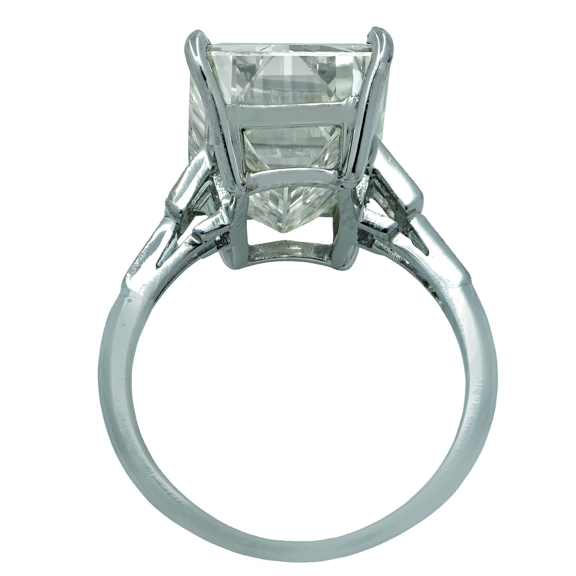 Simply stunning engagement ring crafted in platinum showcasing a stunning emerald cut diamond weighing an impressive 12.84 carats, Y-Z color GIA, VVS clarity. The band of the ring is adorned with 6 baguettes weighing .60 carats, I-J color, VS
